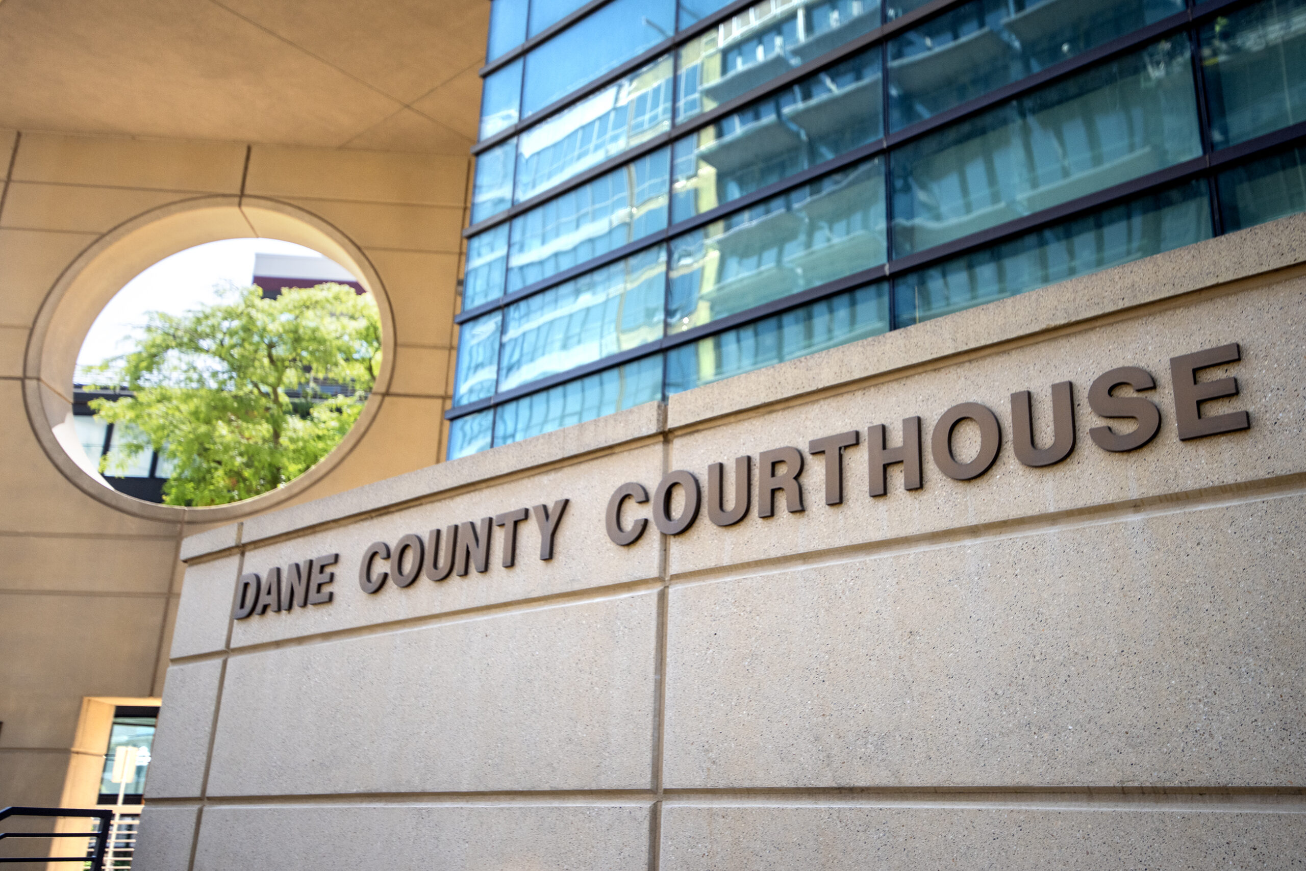 A sign says "Dane County Courthouse" on the outside of a building.