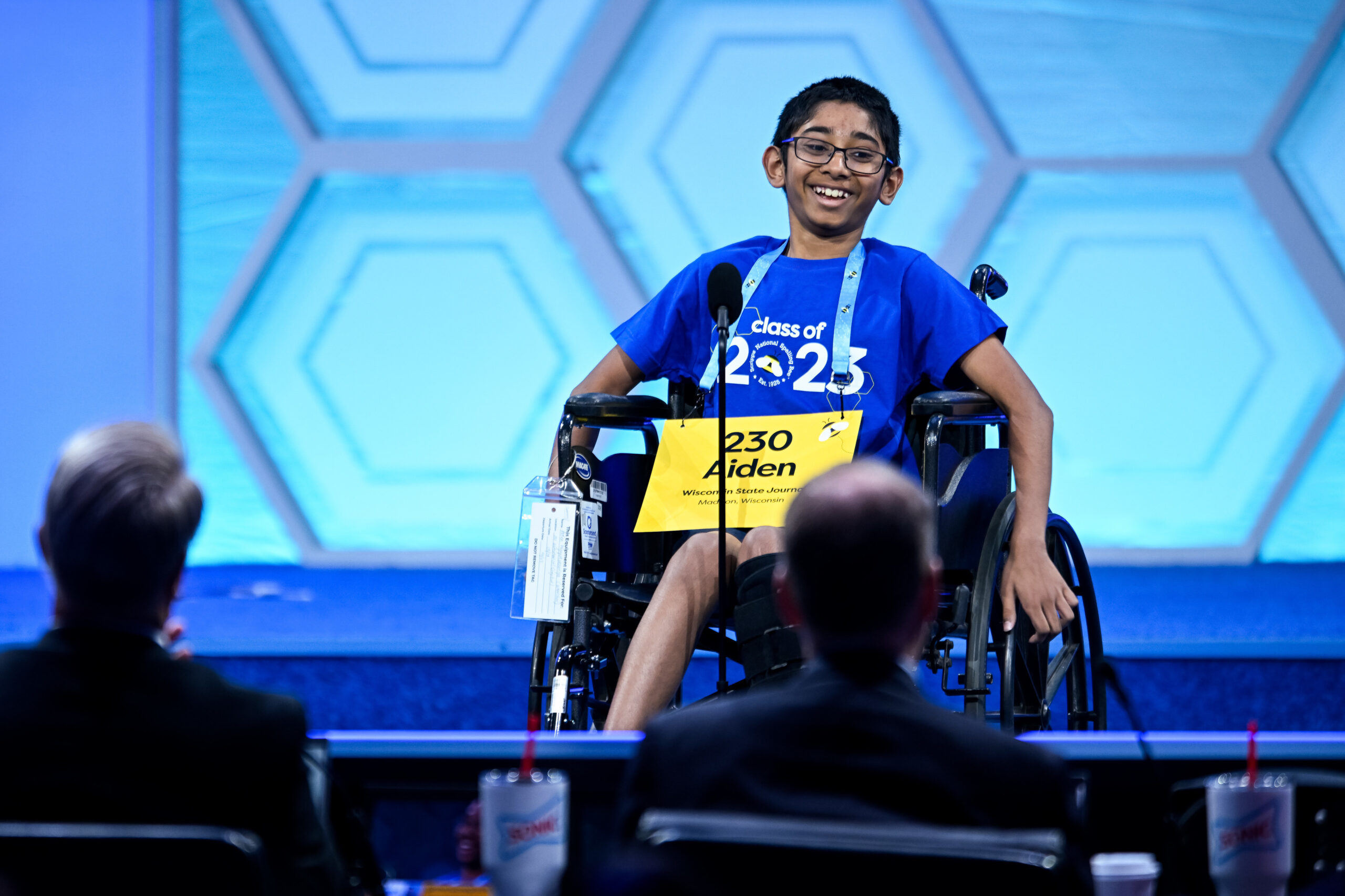 a boy in a wheelchair competes in a spelling bee