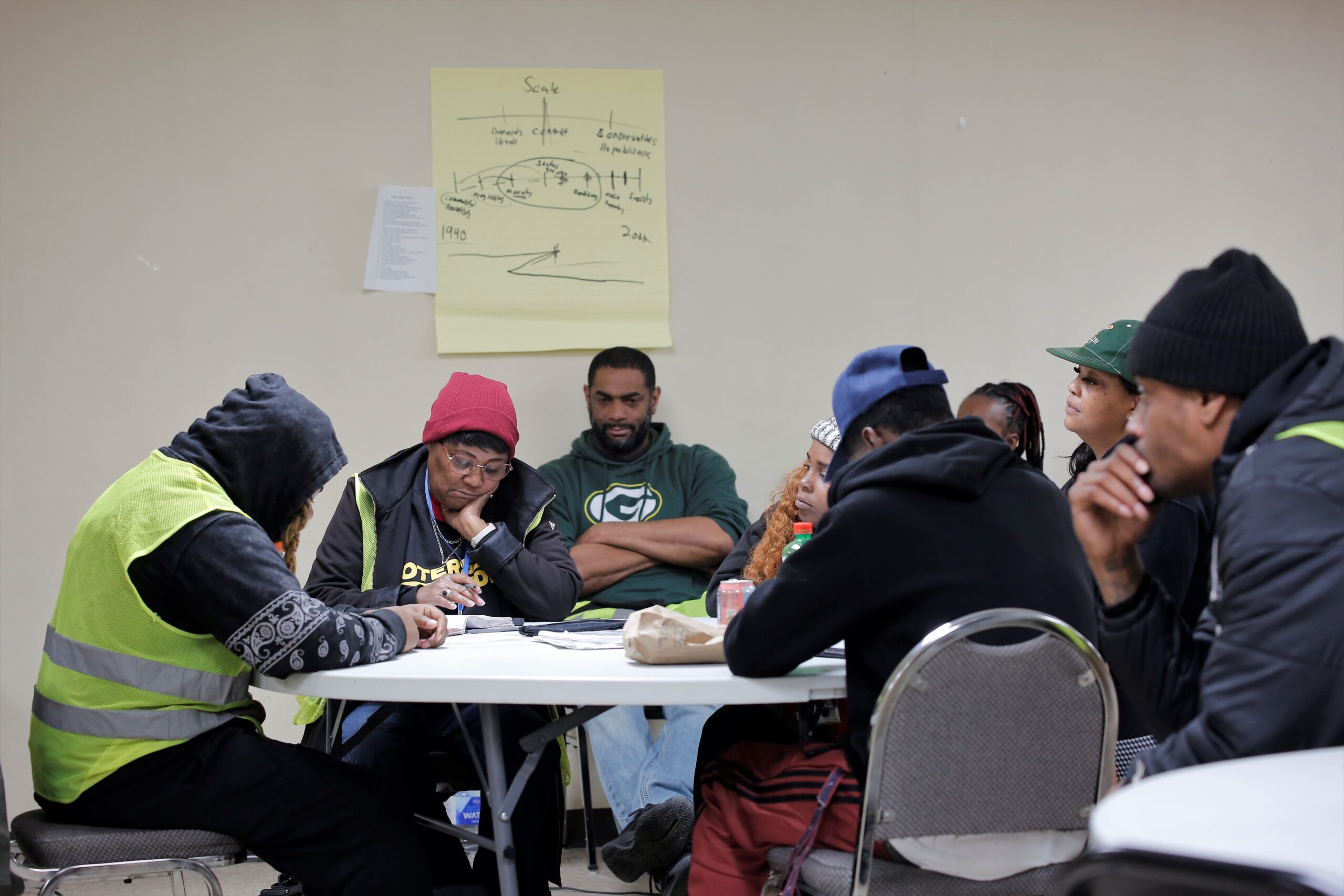 BLOC canvassers take notes and listen for instructions and procedures at the spring election headquarters in Milwaukee before going out into the community on April 4, 2023