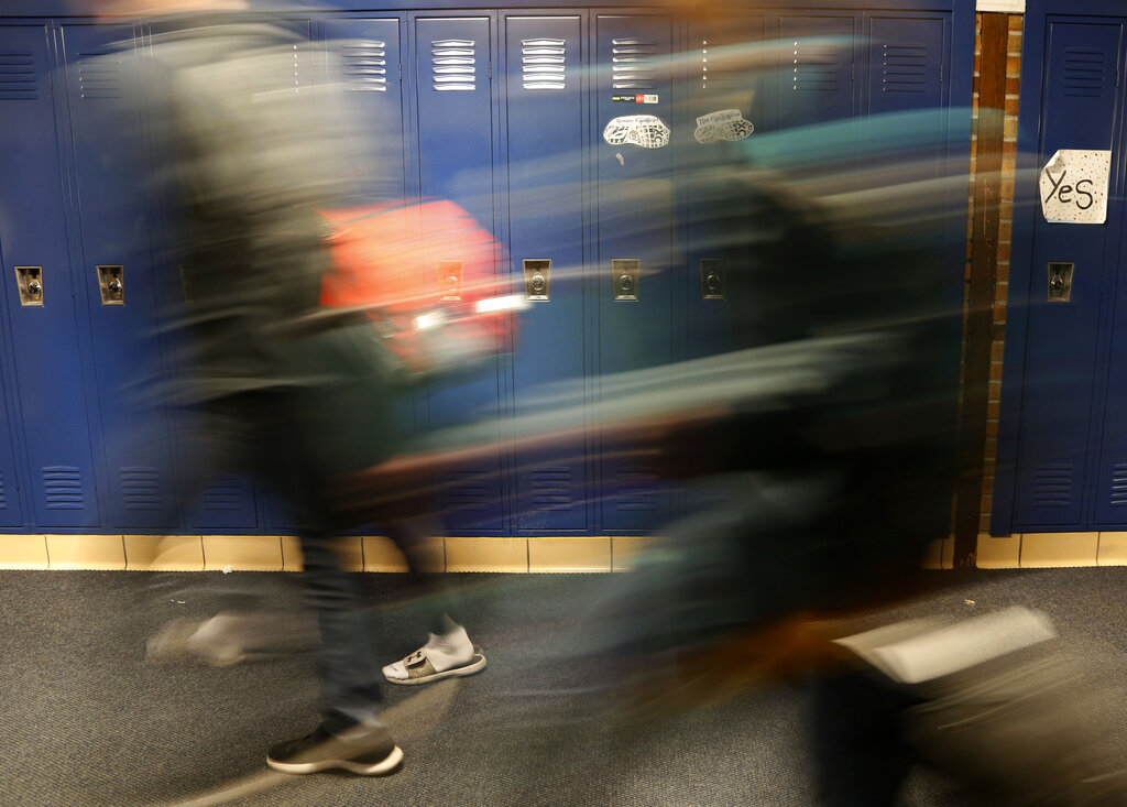 Students walk through a hallway at Cadillac High School in Cadillac, Mich., on Wednesday, April 17, 2019