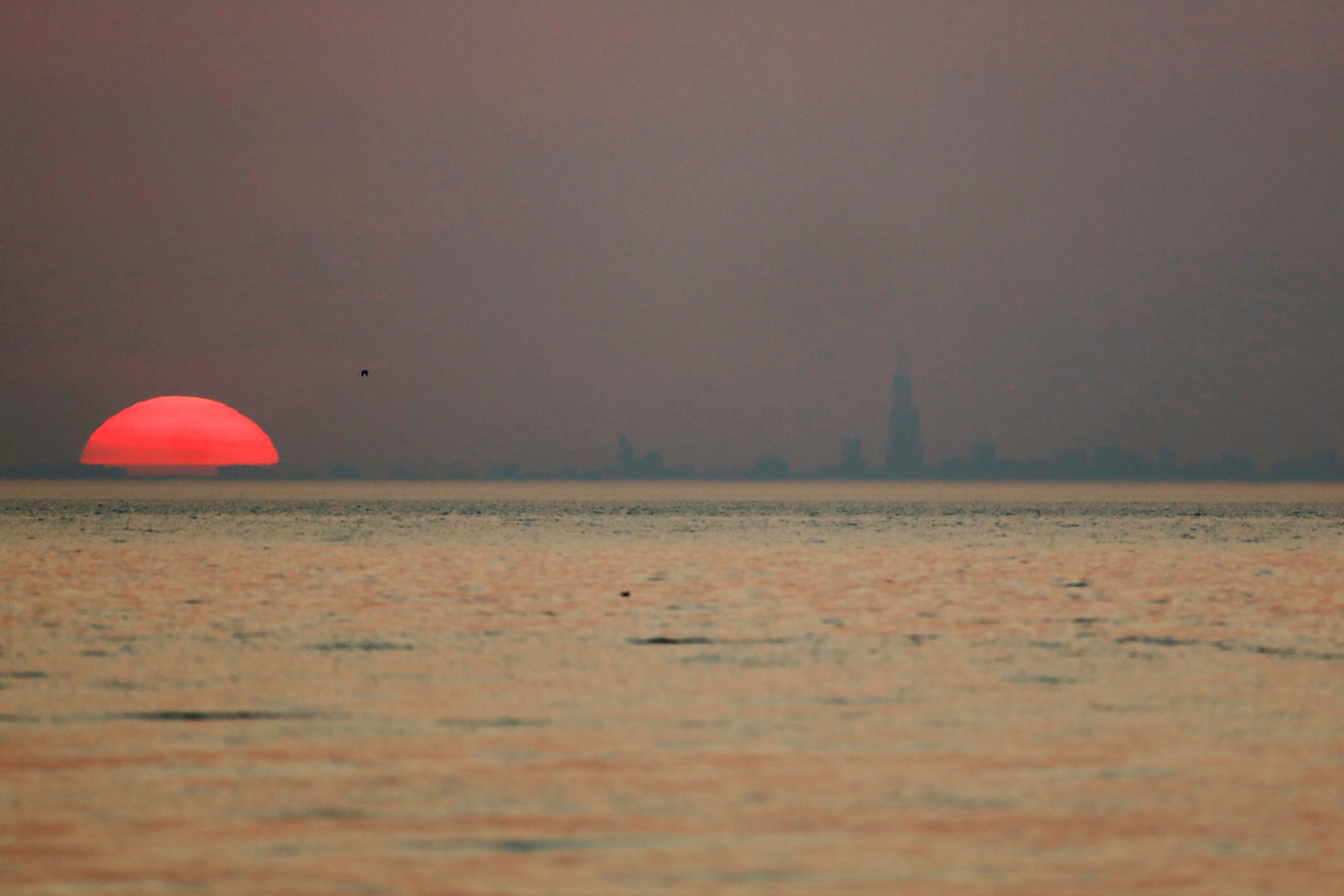 Chicago skyline appears through haze from wildfires in the American West.