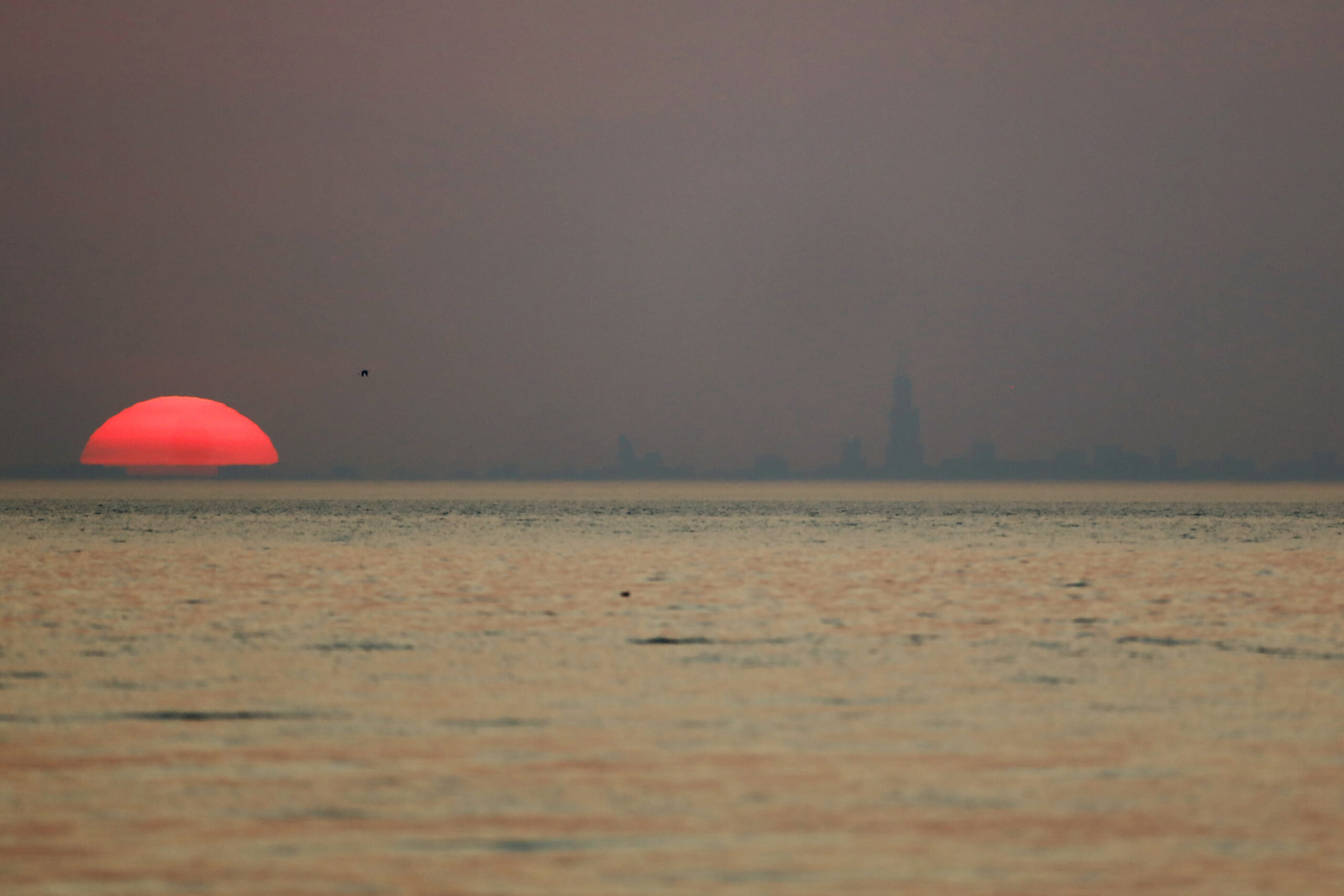 Chicago skyline appears through haze from wildfires in the American West.