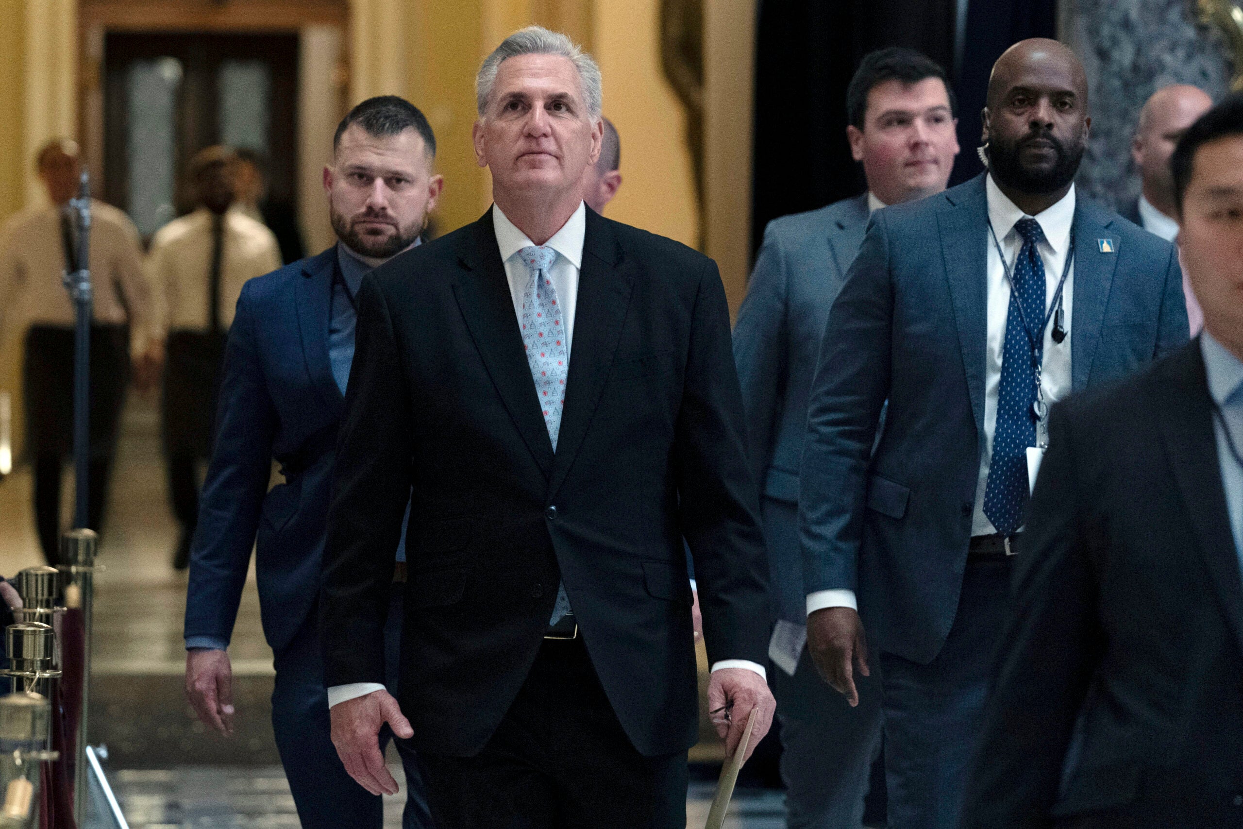 U.S. Speaker Kevin McCarthy walking in the U.S. Capitol with several other people