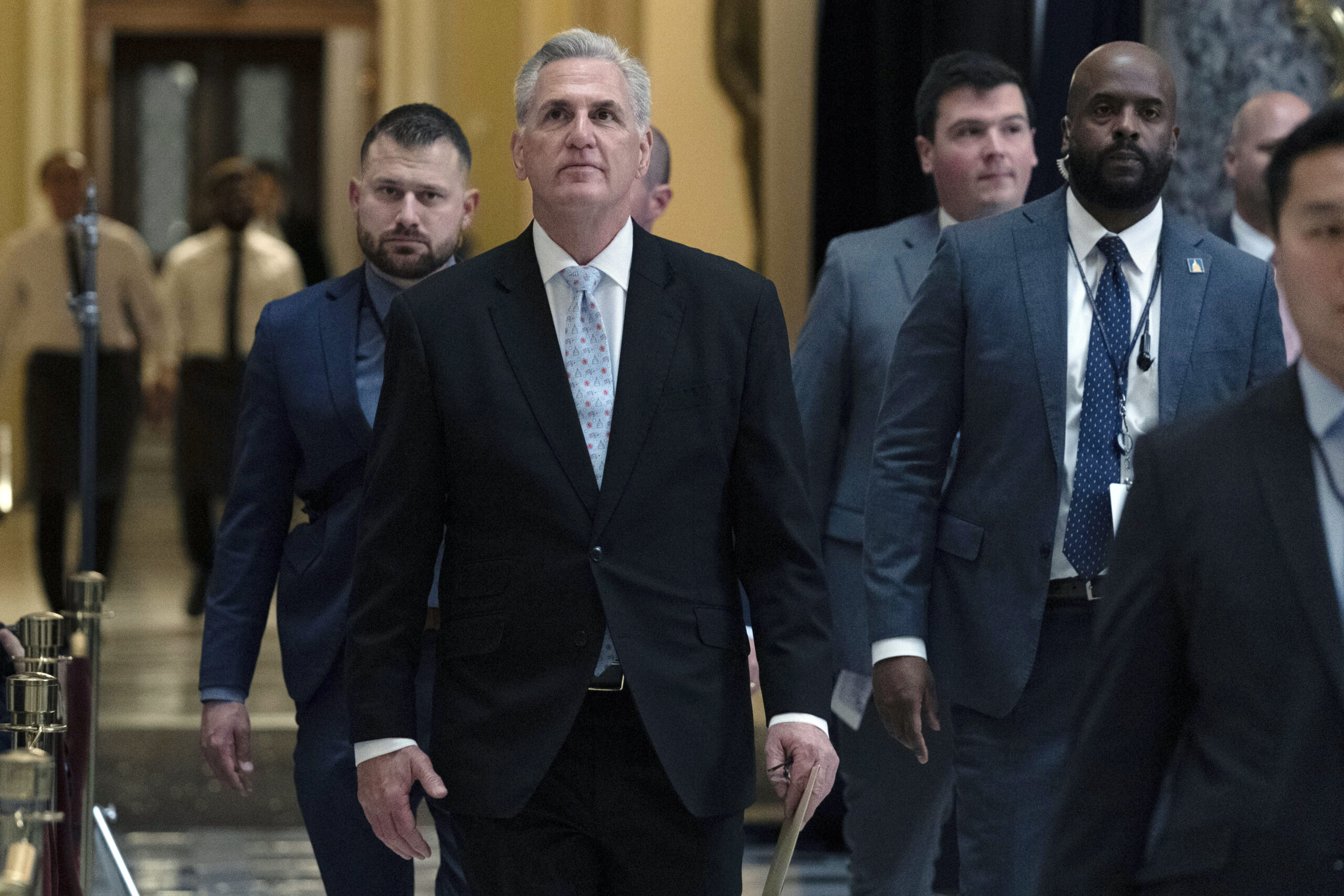 U.S. Speaker Kevin McCarthy walking in the U.S. Capitol with several other people