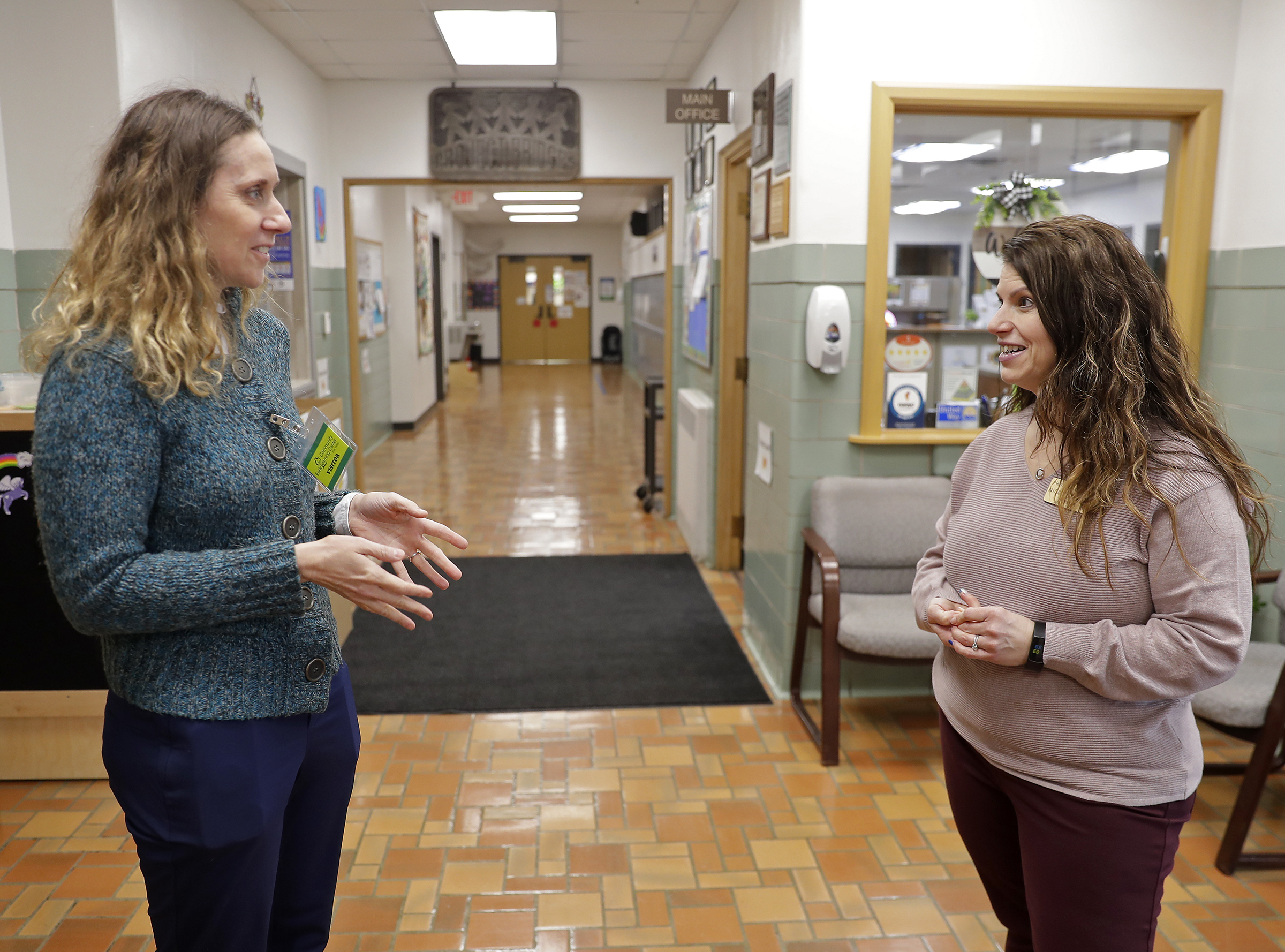 Wisconsin Department of Children and Families Secretary Emilie Amundson talks with director Nicole Desten during a visit at Bridges Child Enrichment Center