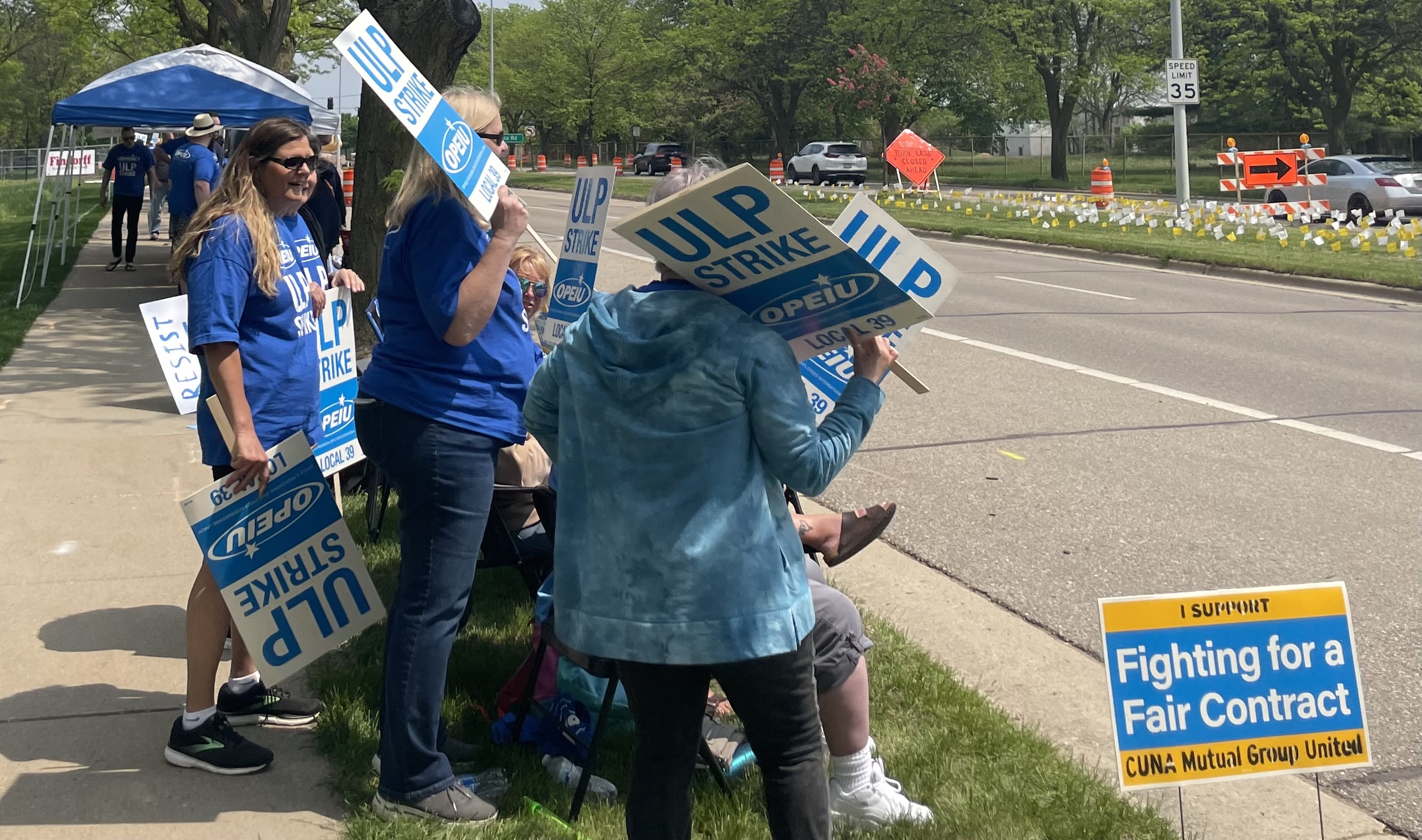 Union workers strike outside CUNA Mutual in Madison.