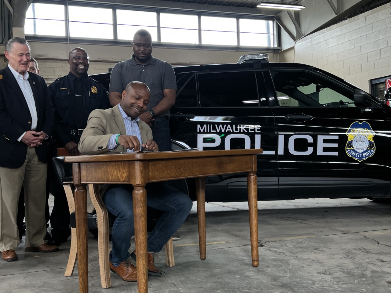 milwaukee mayor cavalier johnson signs a bill