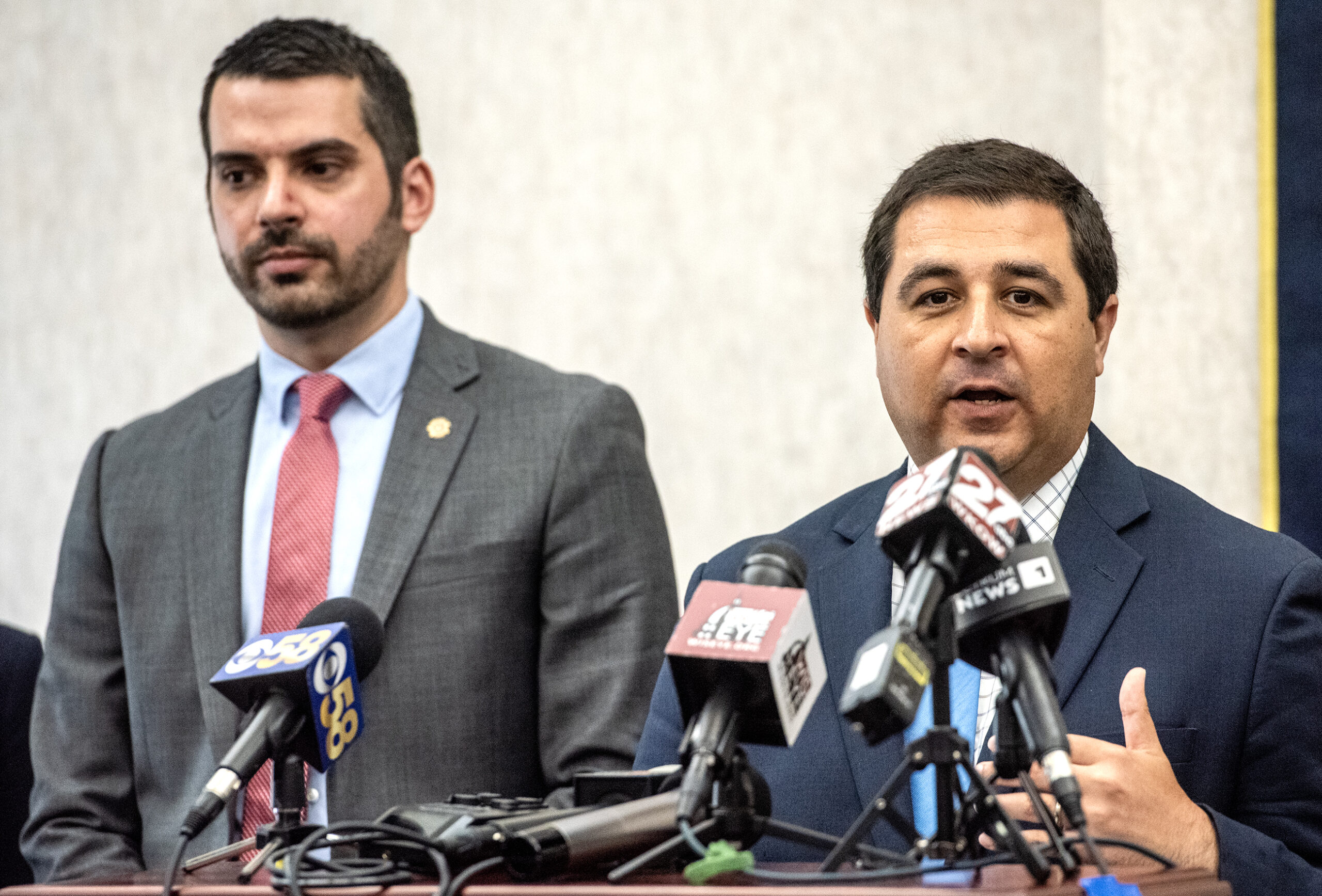 People speak at a press conference.