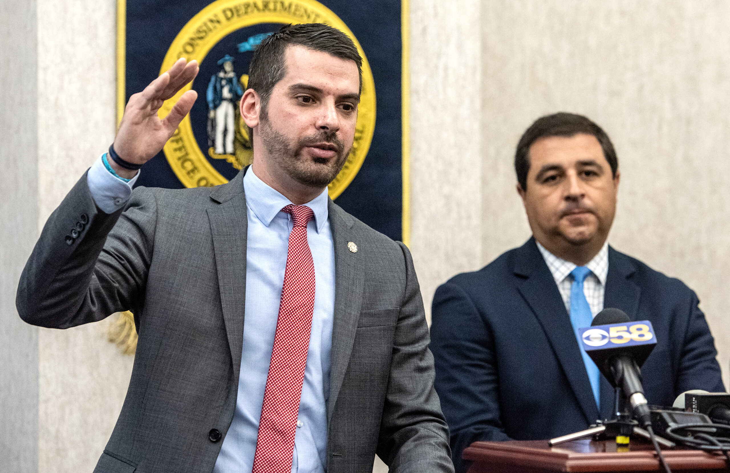 People speak at a press conference.