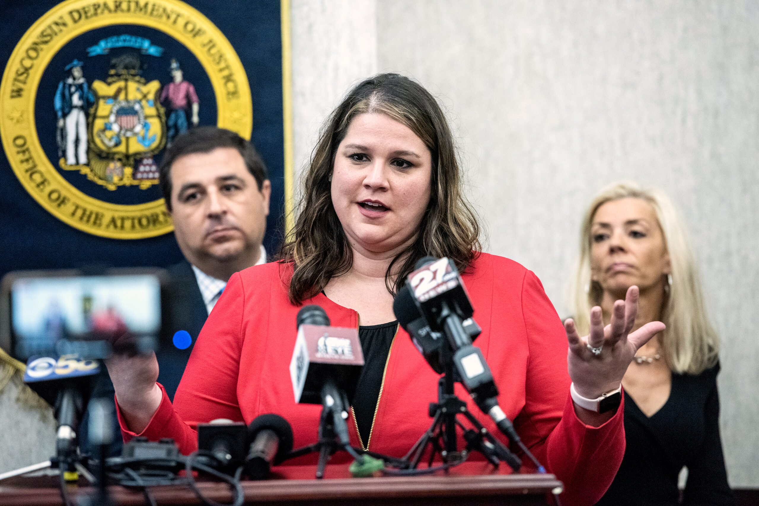 People speak at a press conference.