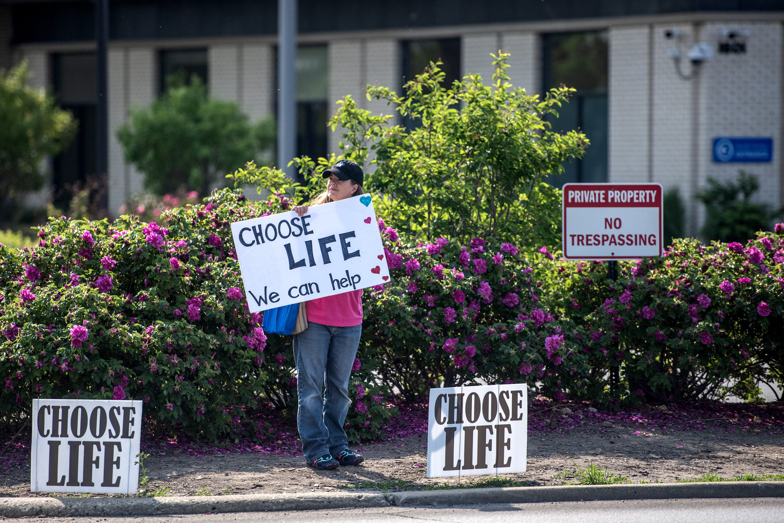 A protester holds a sign that says "Choose Life."