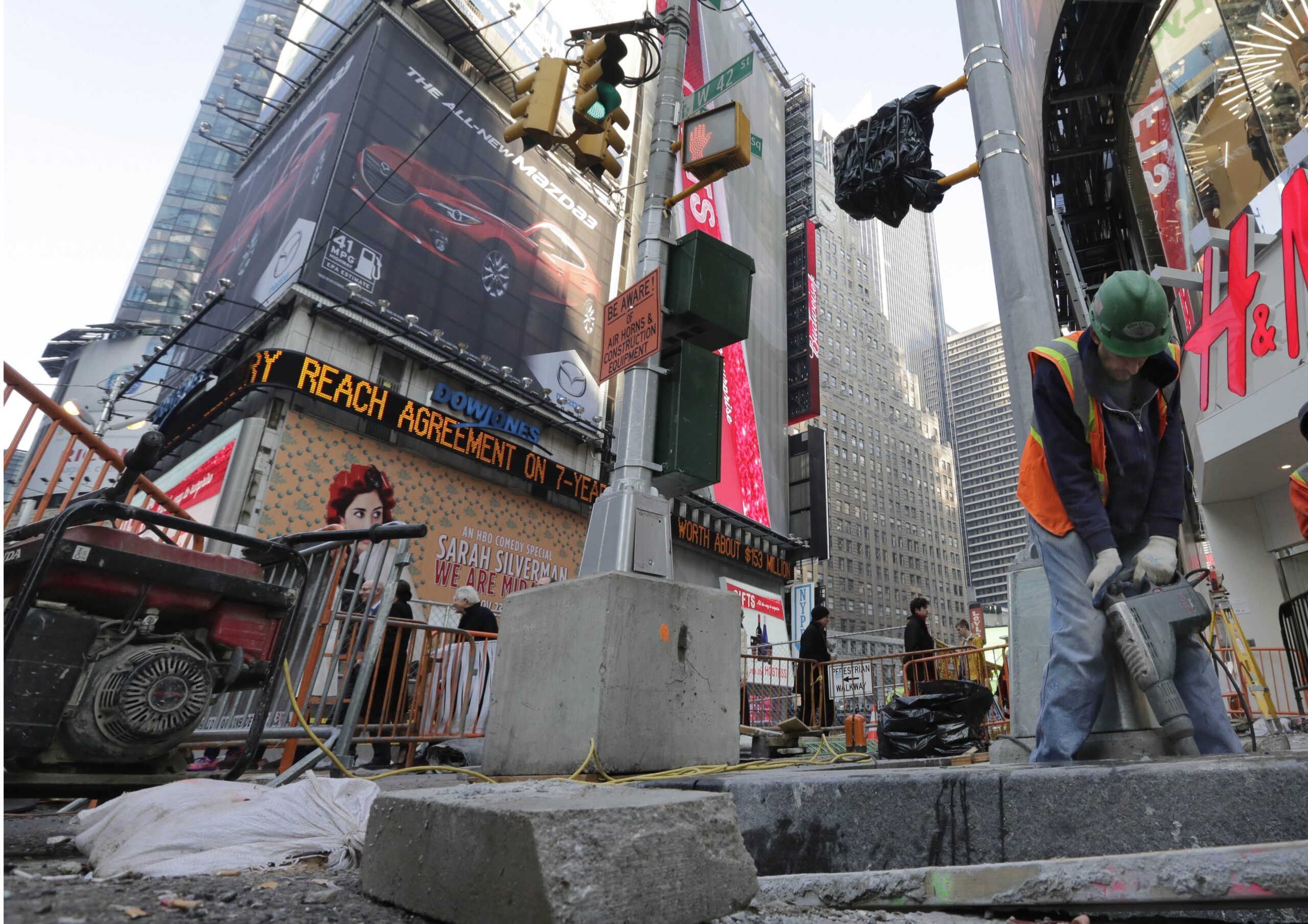 A workers operates a jackhammer in New York City's Times Square