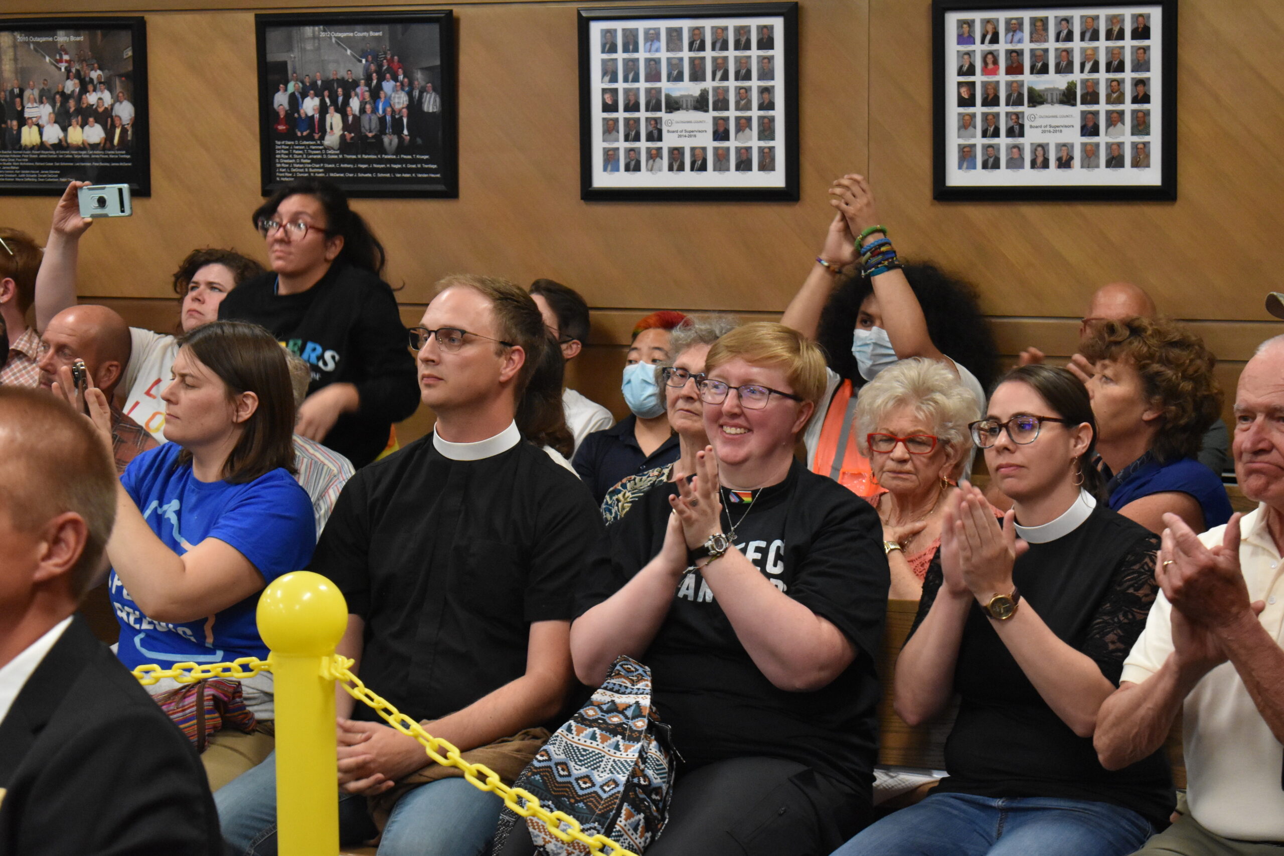 Trans-rights activists in the audience applaud the Outagamie County Board for voting to censure Supervisor Tim Hermes