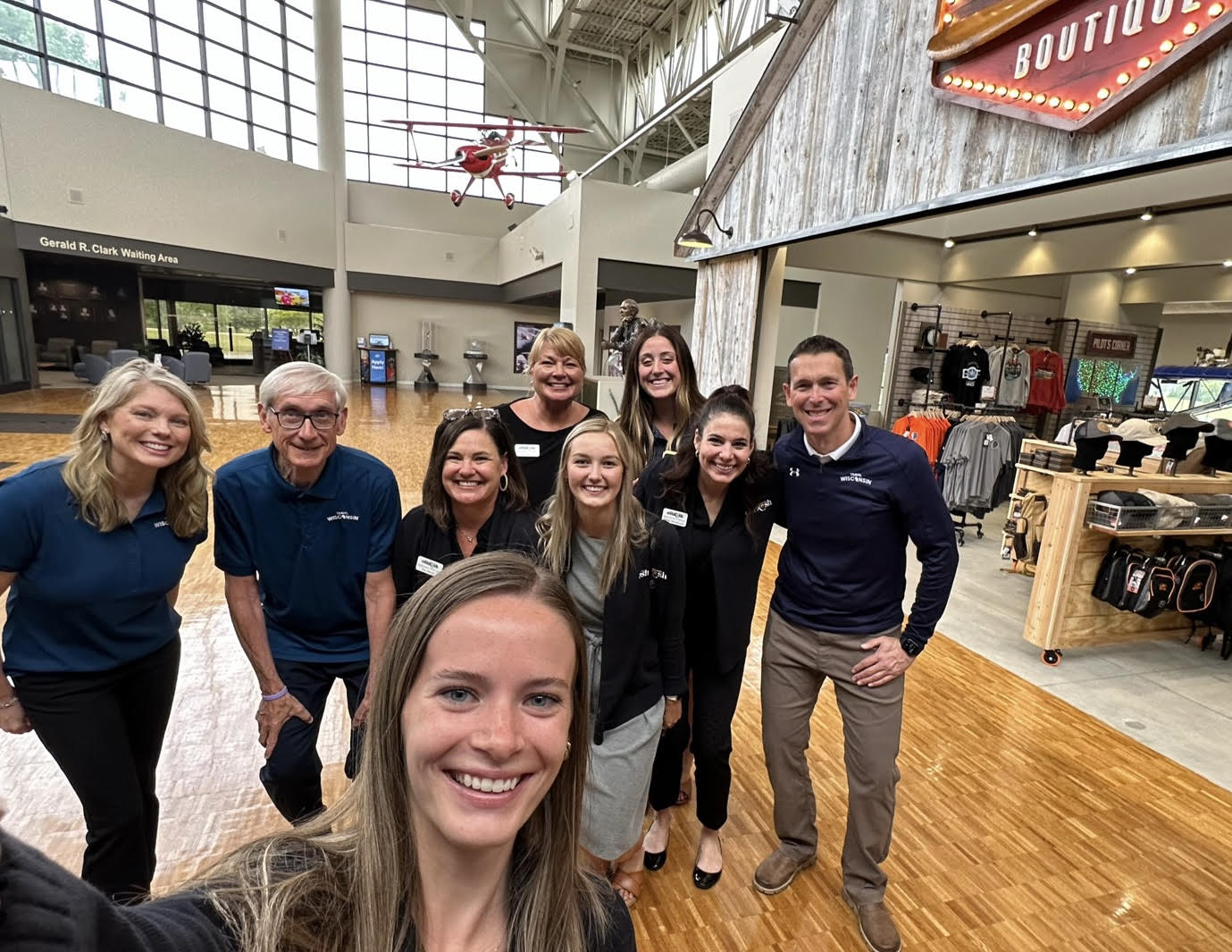 Wisconsin Department of Tourism Secretary Anne Sayers and Gov. Tony Evers take a selfie with Discover Oshkosh Officials