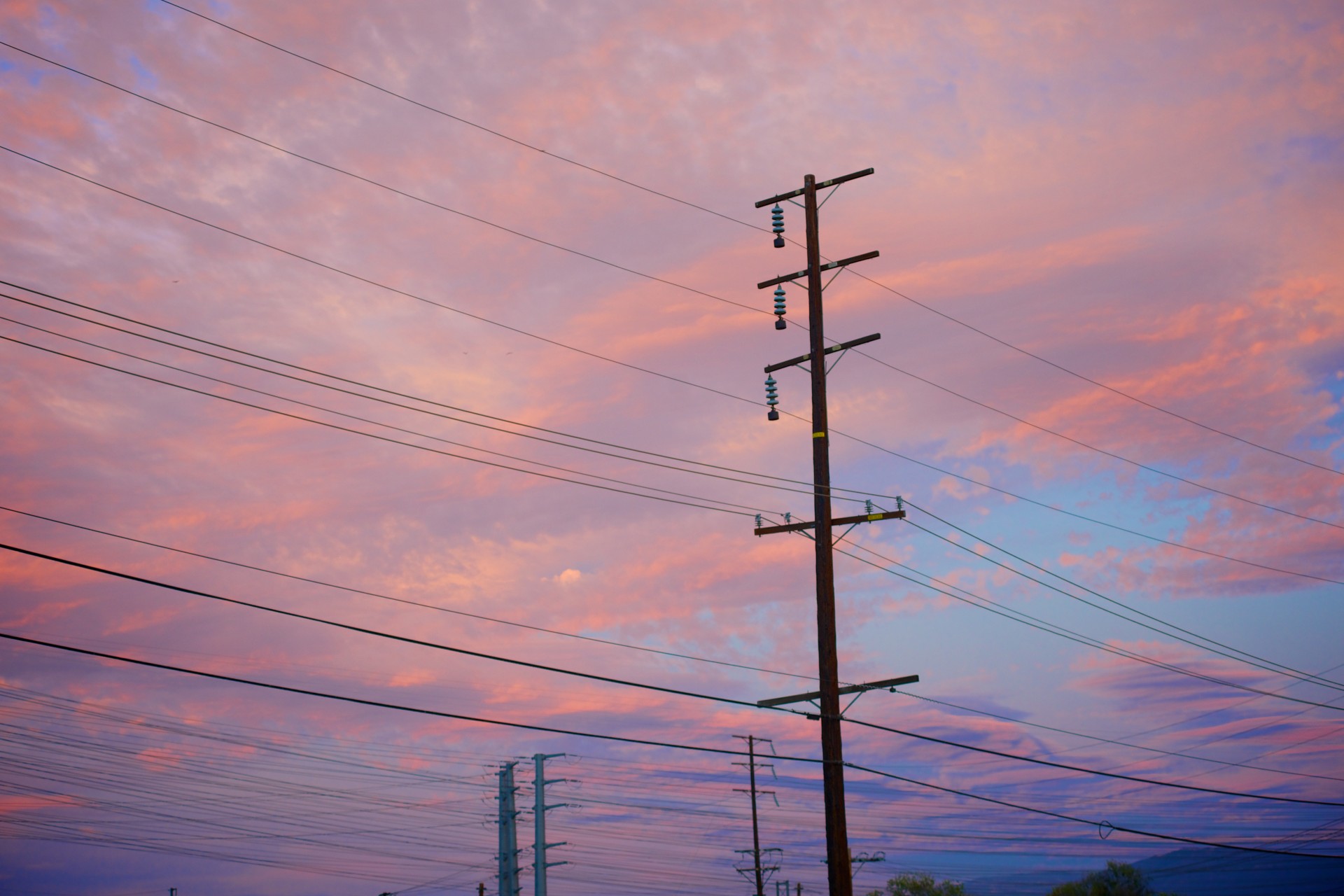 An electrical power line at sunset.