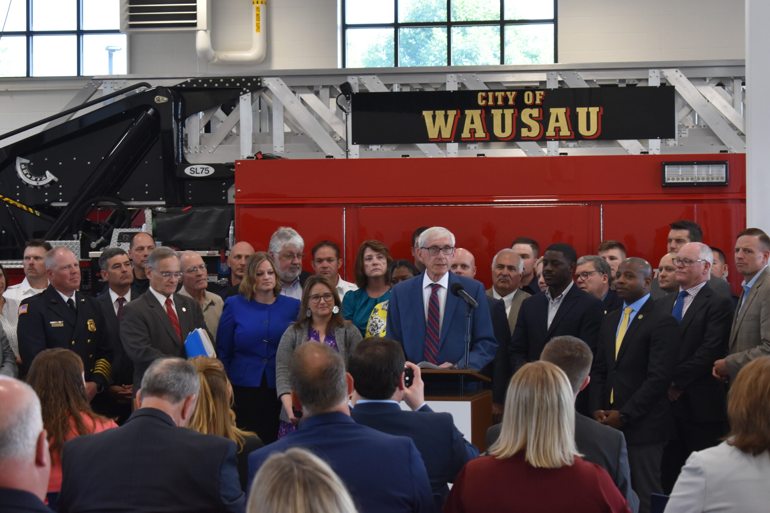 Gov. Tony Evers addresses attendees of a bill-signing ceremony for a sweeping overhaul of state shared funding