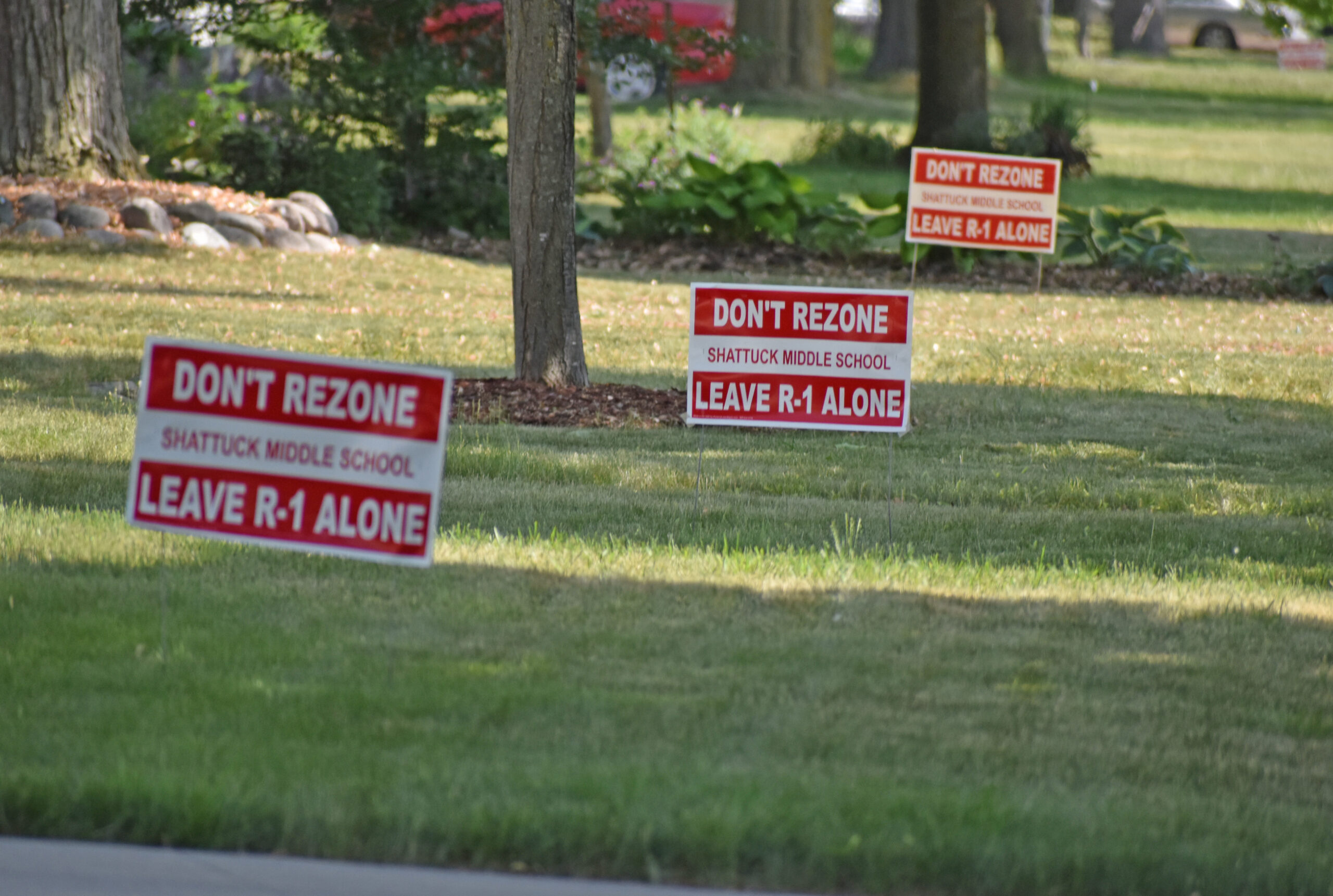 Multiple signs protest a plan that would've turned Neenah's Shattuck Middle School into apartments.