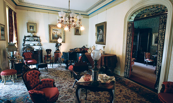 An ornate parlor in a Victorian style mansion.