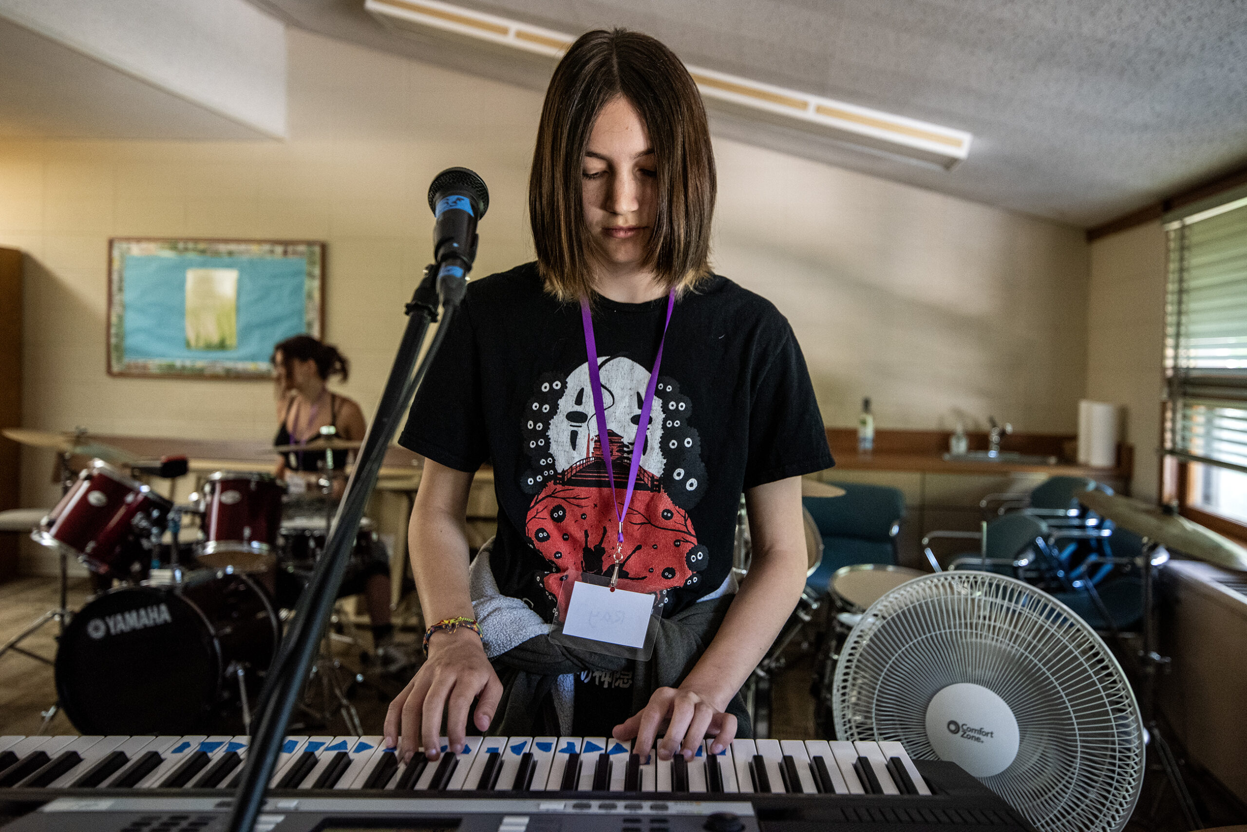 A camper plays the keyboard with other musicians.