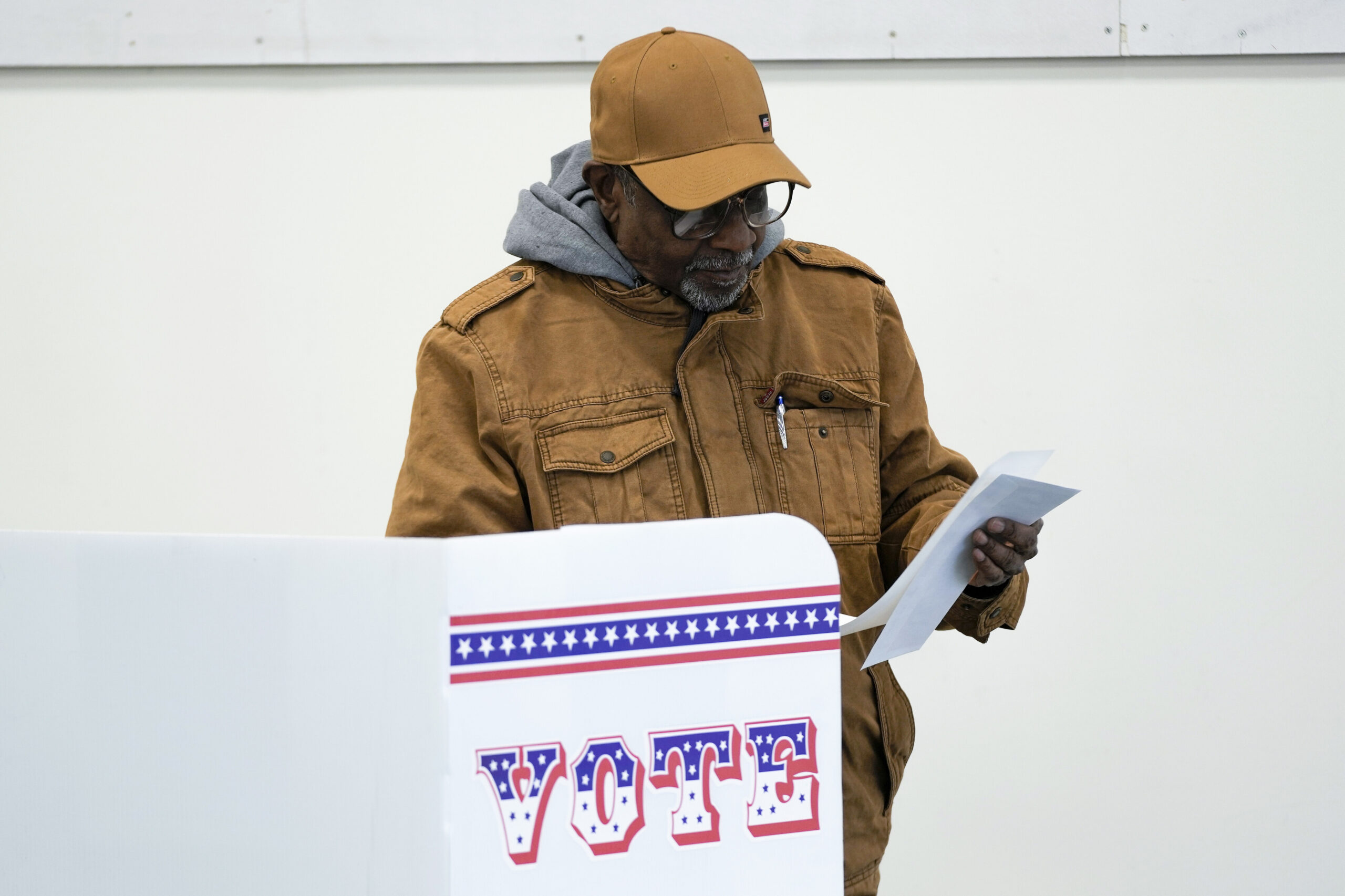 A person filling out an election ballot