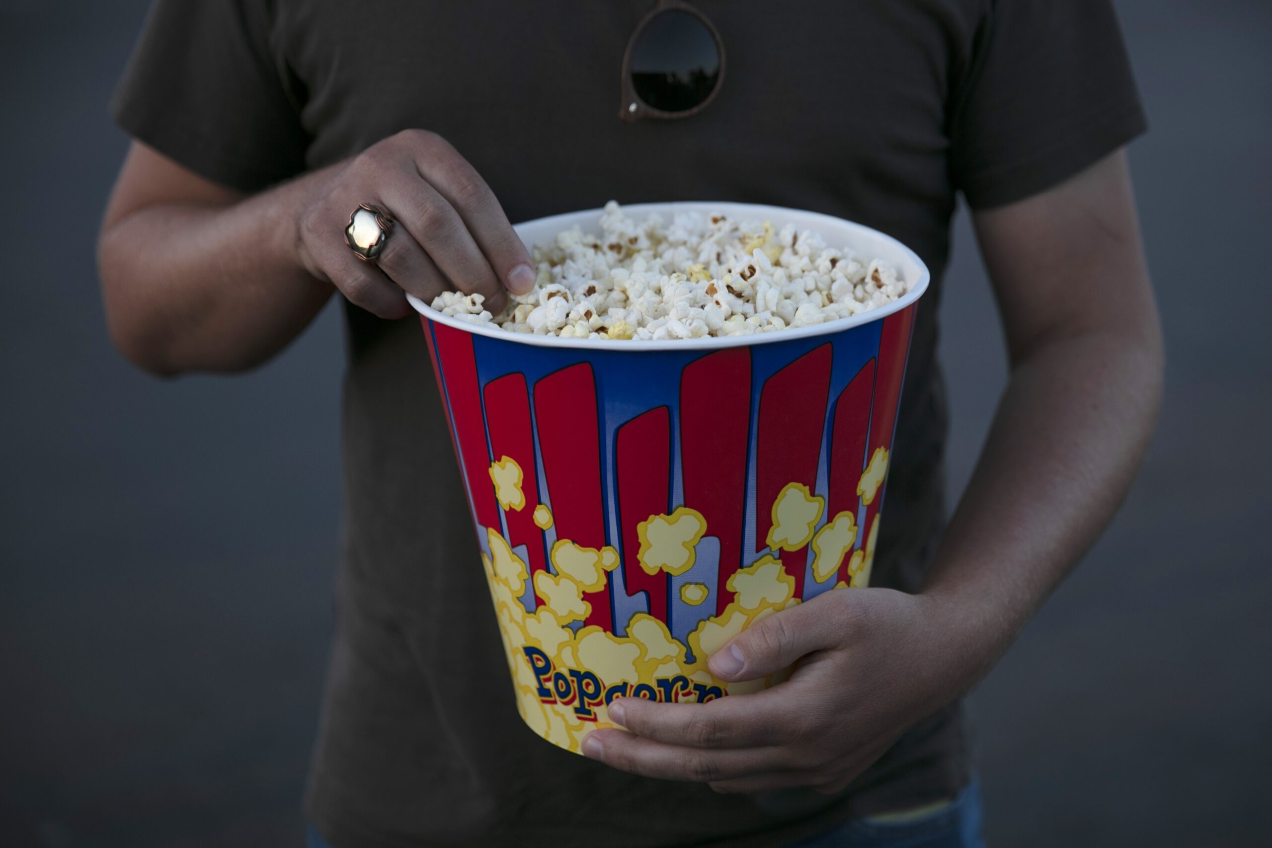 A moviegoer eats popcorn at Mission Tiki drive-in theater
