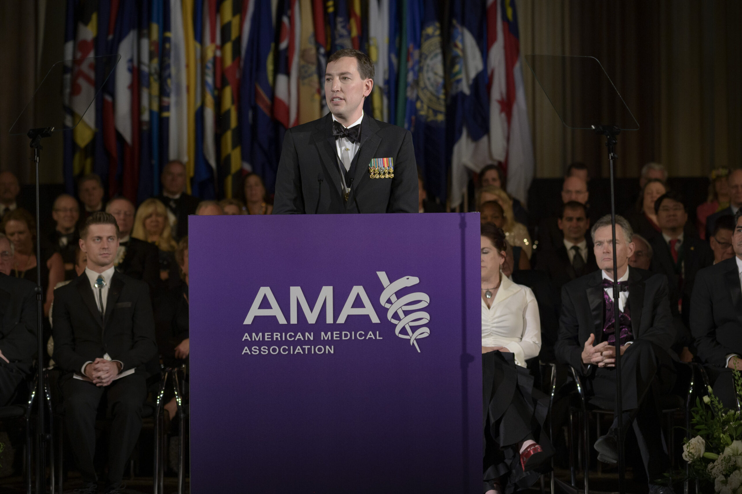 A man speaks on stage at an American Medical Association event