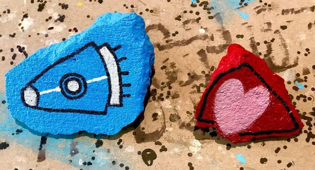 Concrete slab painted neon blue on the left, the right in dark red with a pink heart in the center.