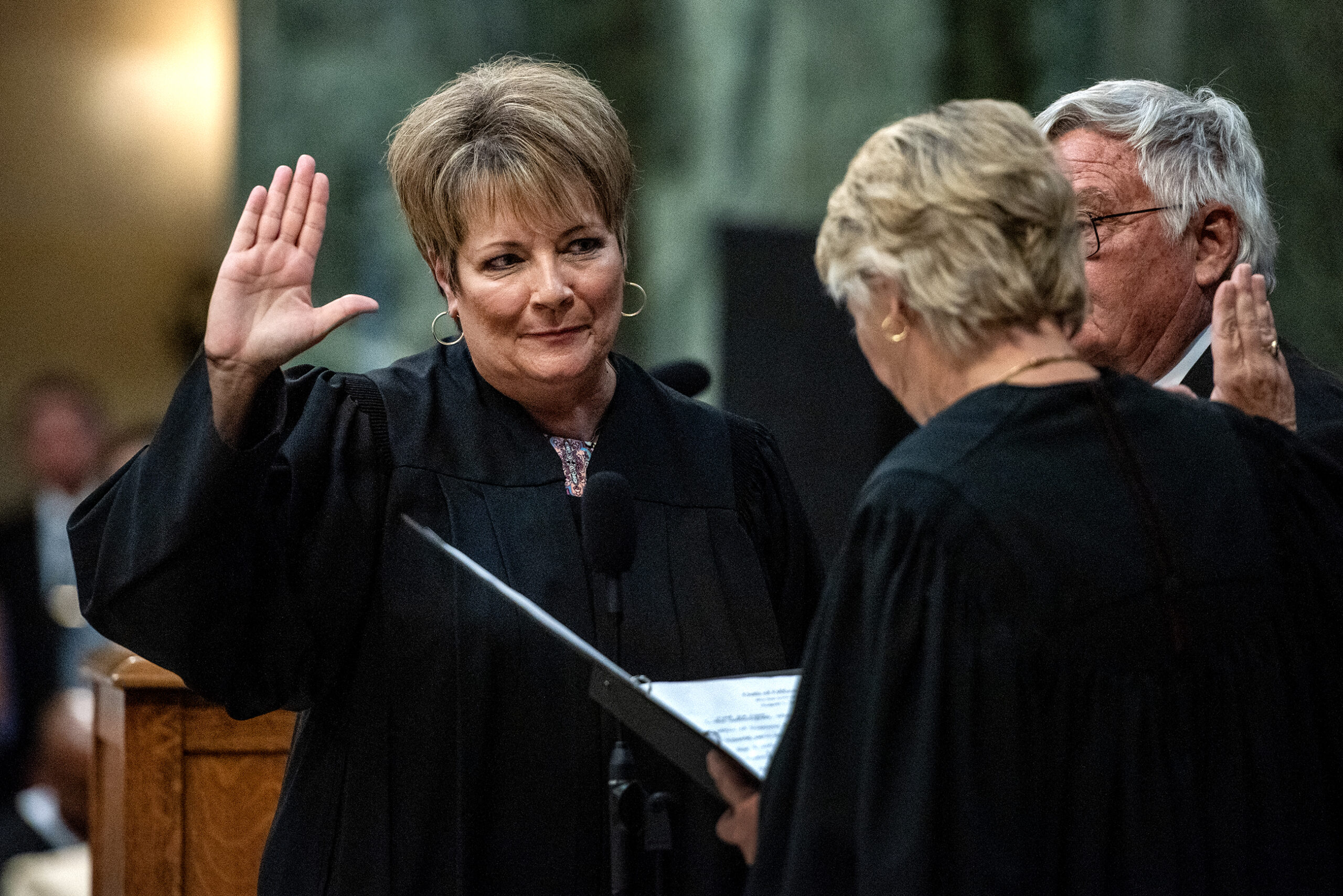 Janet Protasiewicz raises her hand to swear in.