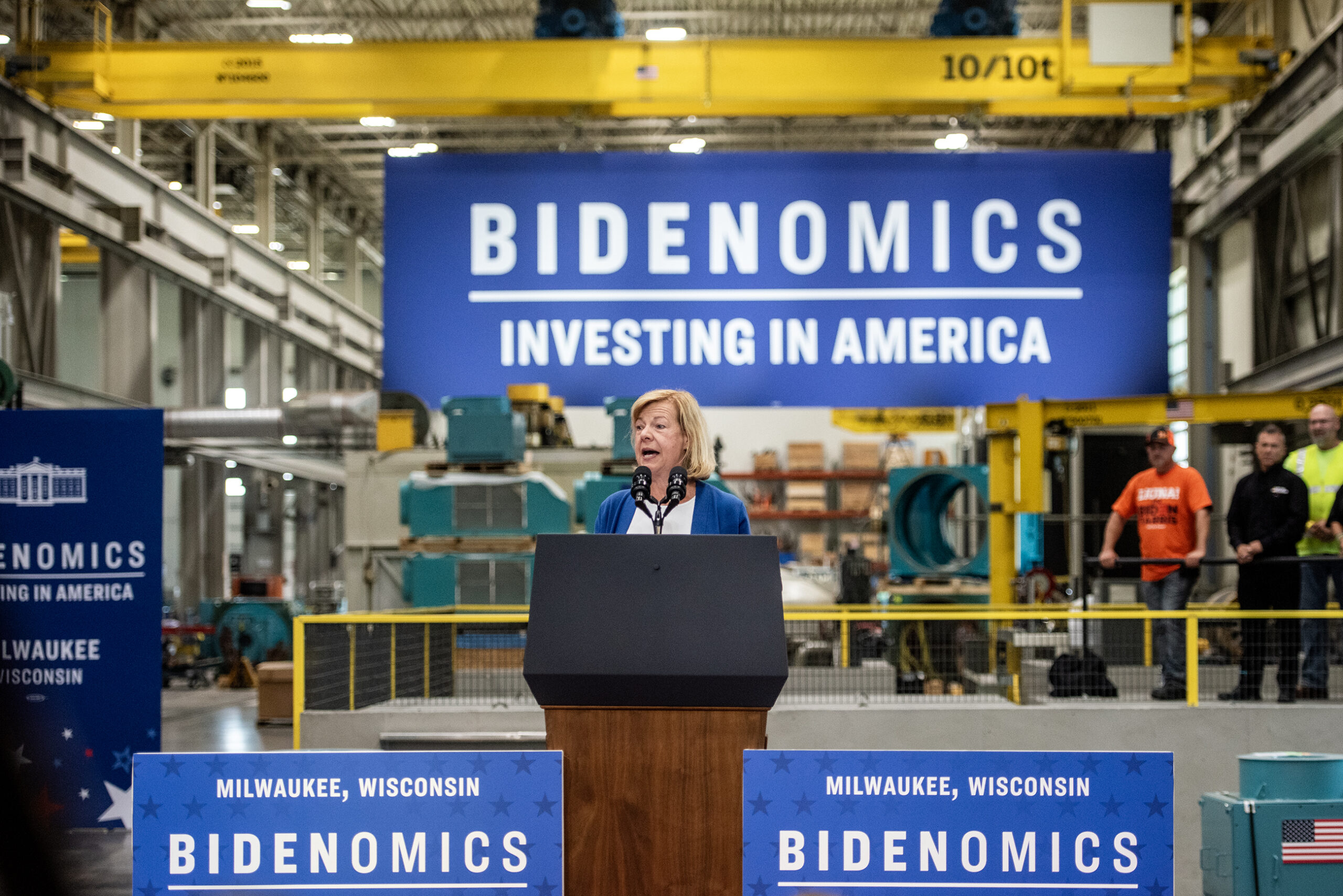 Sen. Tammy Baldwin is seen on stage behind a podium.