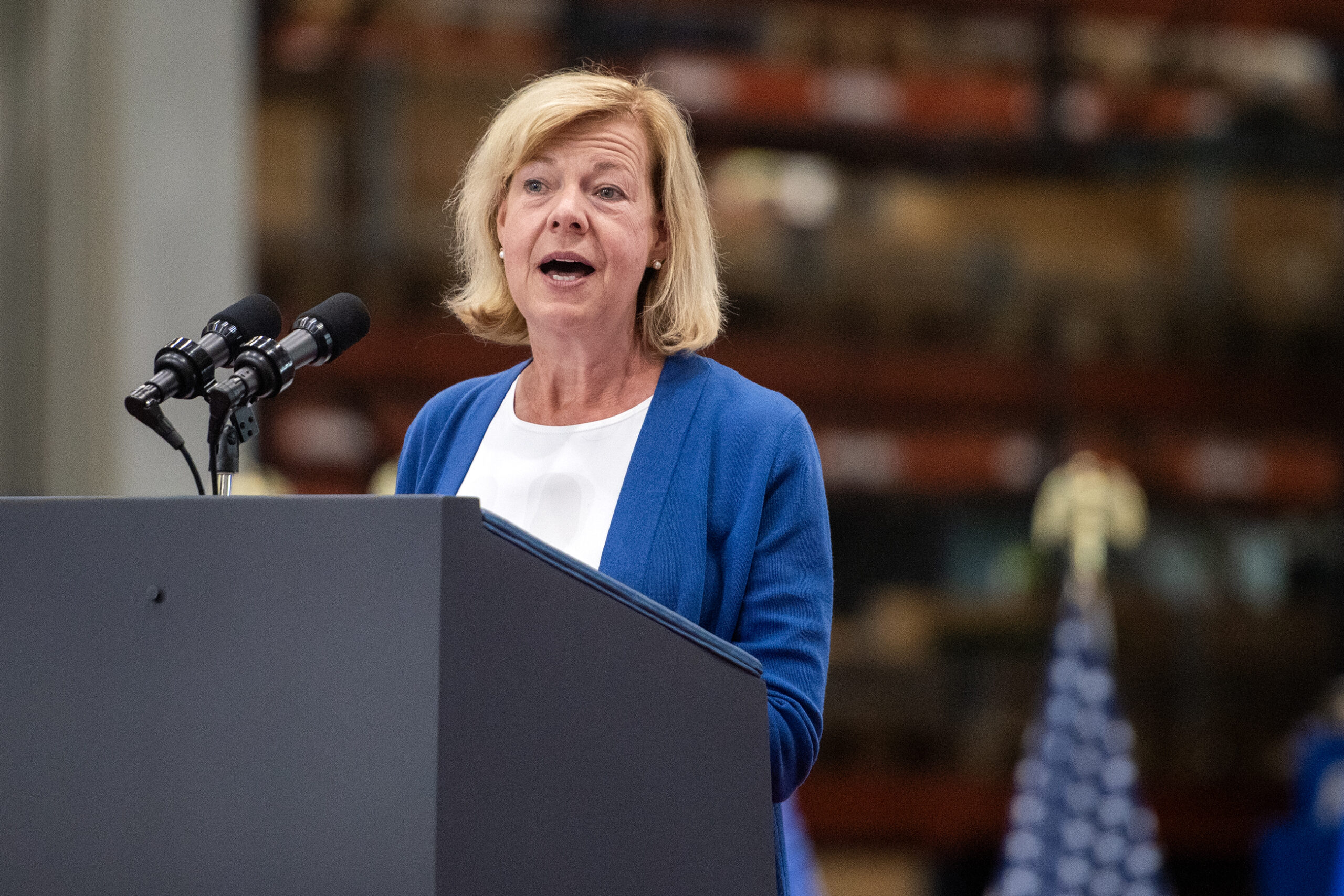 Sen. Tammy Baldwin speaks at a podium.