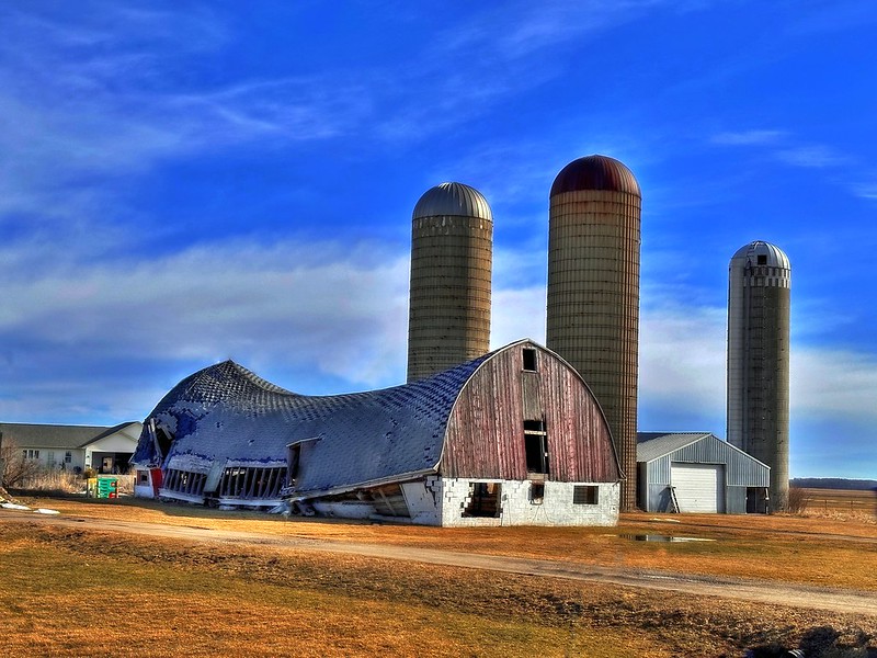 A barn and grain silos