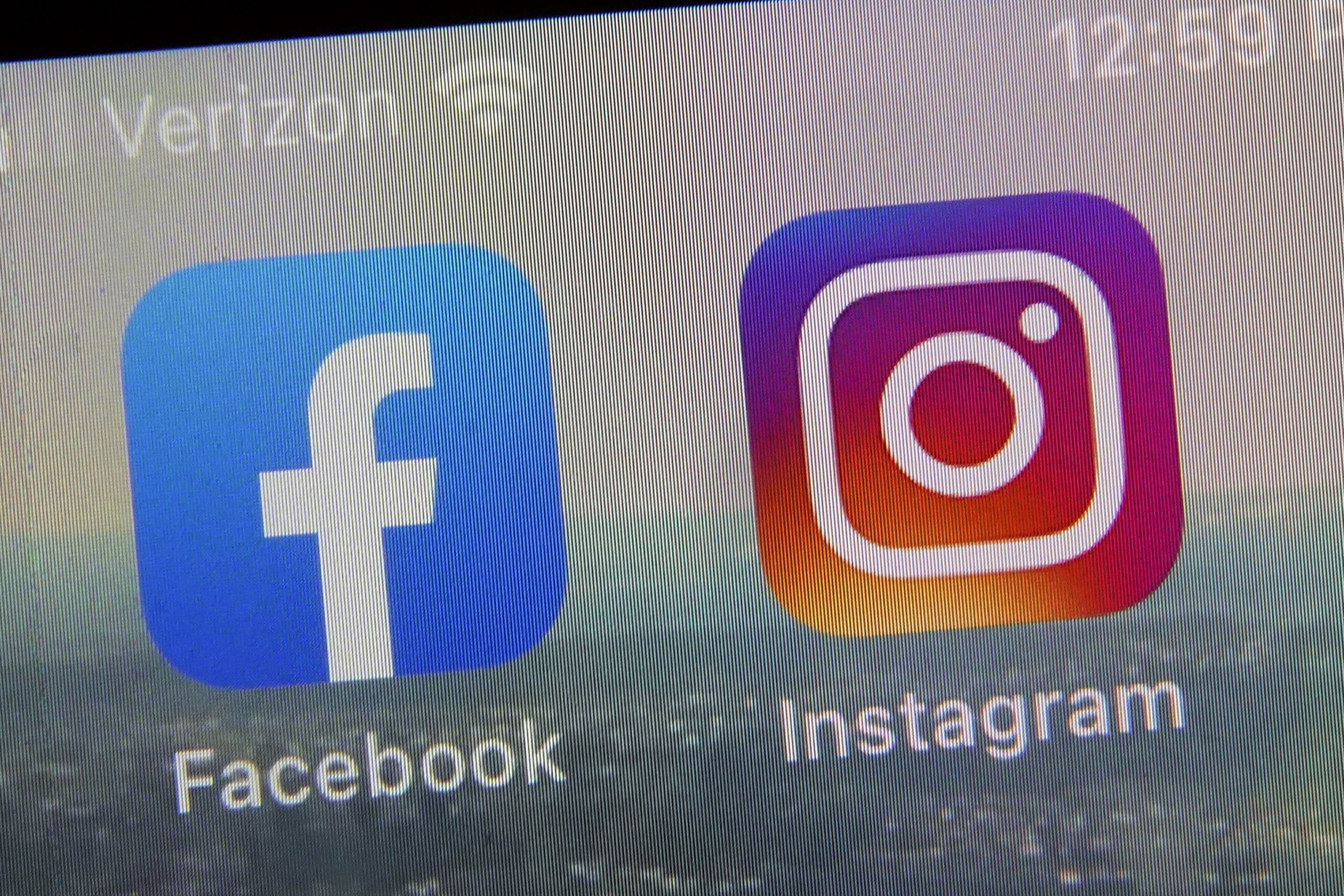 A photo of a phone screen showing the app icons for Facebook and Instagram