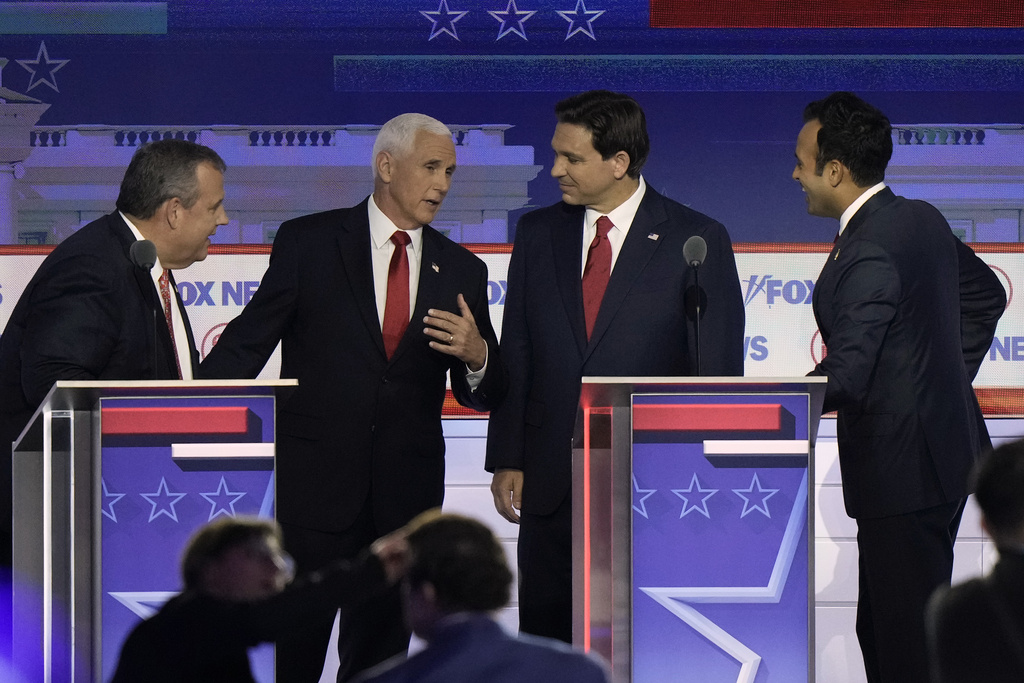 Former New Jersey Gov. Chris Christie, former Vice President Mike Pence, Florida Gov. Ron DeSantis and businessman Vivek Ramaswamy talk during break in a Republican presidential primary debate