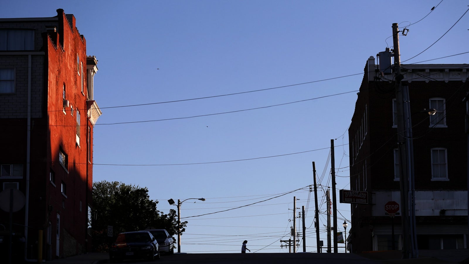 A person walks across a street