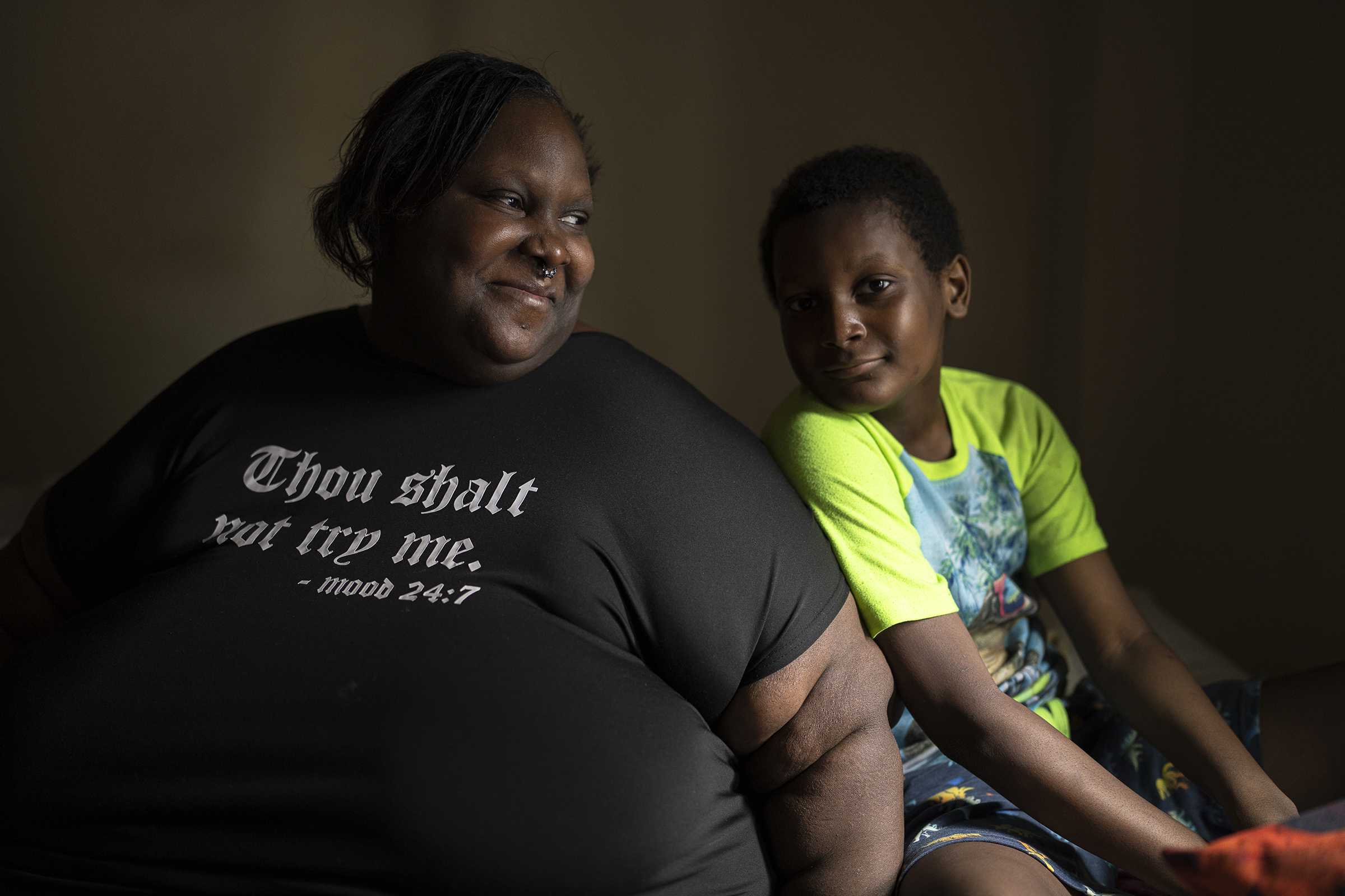 Deanna Branch, 33, and her middle son, Aiden, 9, sit in the bedroom of their one bedroon apartment they are soon to be moving out of on Saturday July 1, 2023 in Milwaukee, Wis.