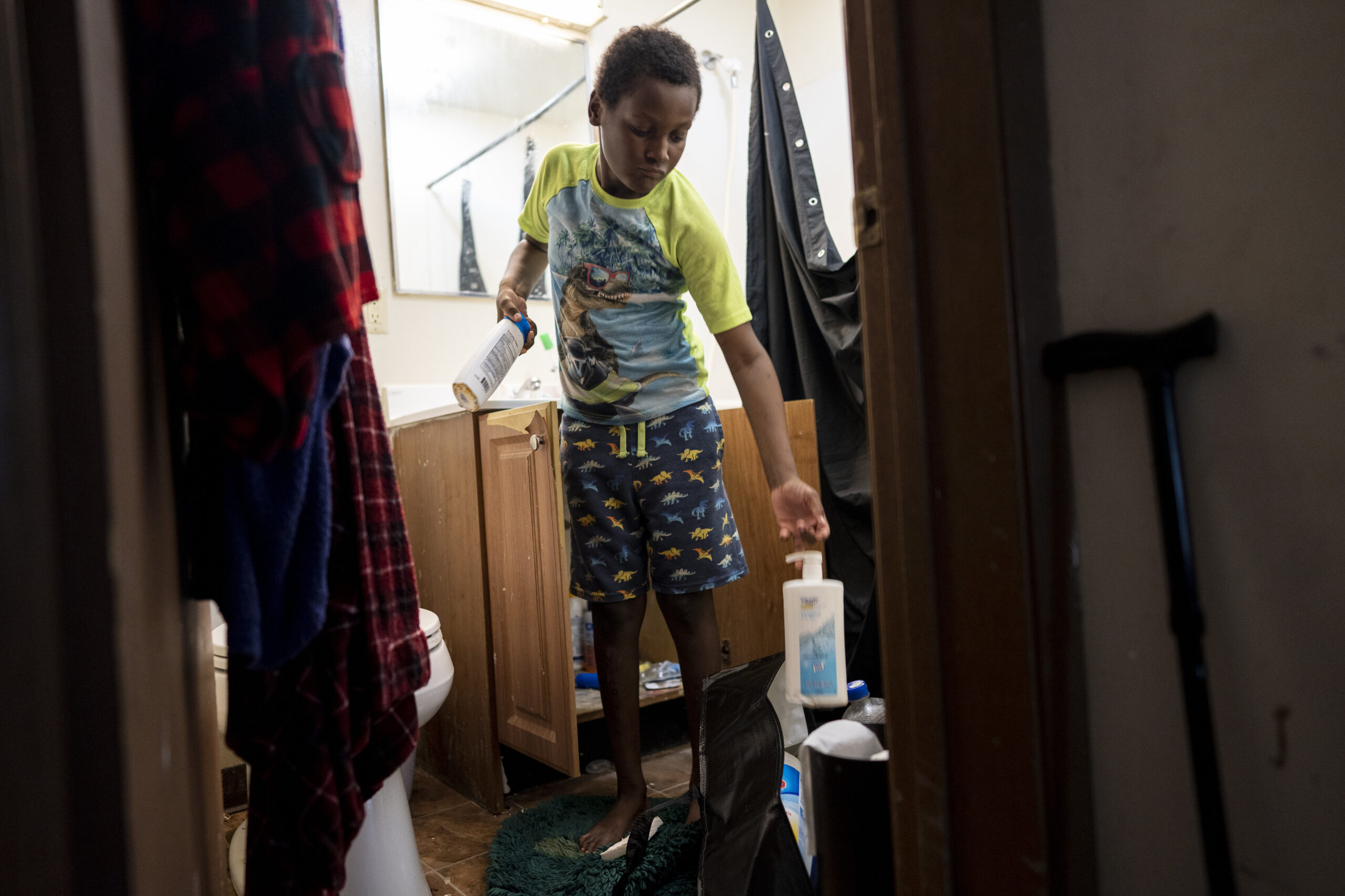 Aiden Branch, 9, packs up items from the bathroom of the one bedroom apartment he lives in with his mom and two siblings on Saturday July 1, 2023 in Milwaukee, Wis. Aidan suffered lead poisoning in the apartment they lived previously and has hyperactivity