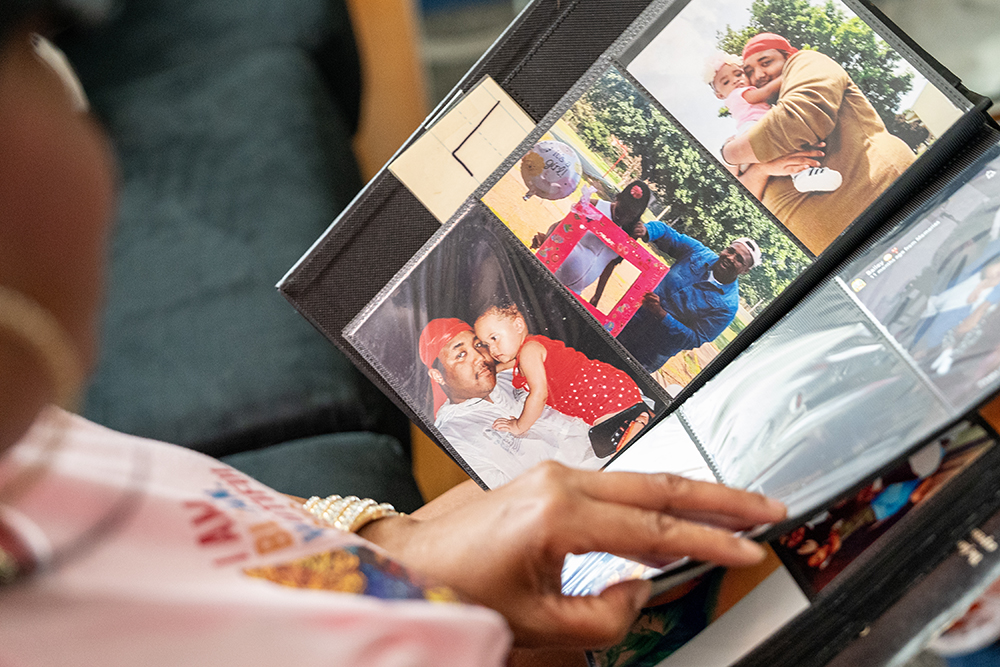 Antoinette Broomfield looks through photos of her late son Le’Quon McCoy