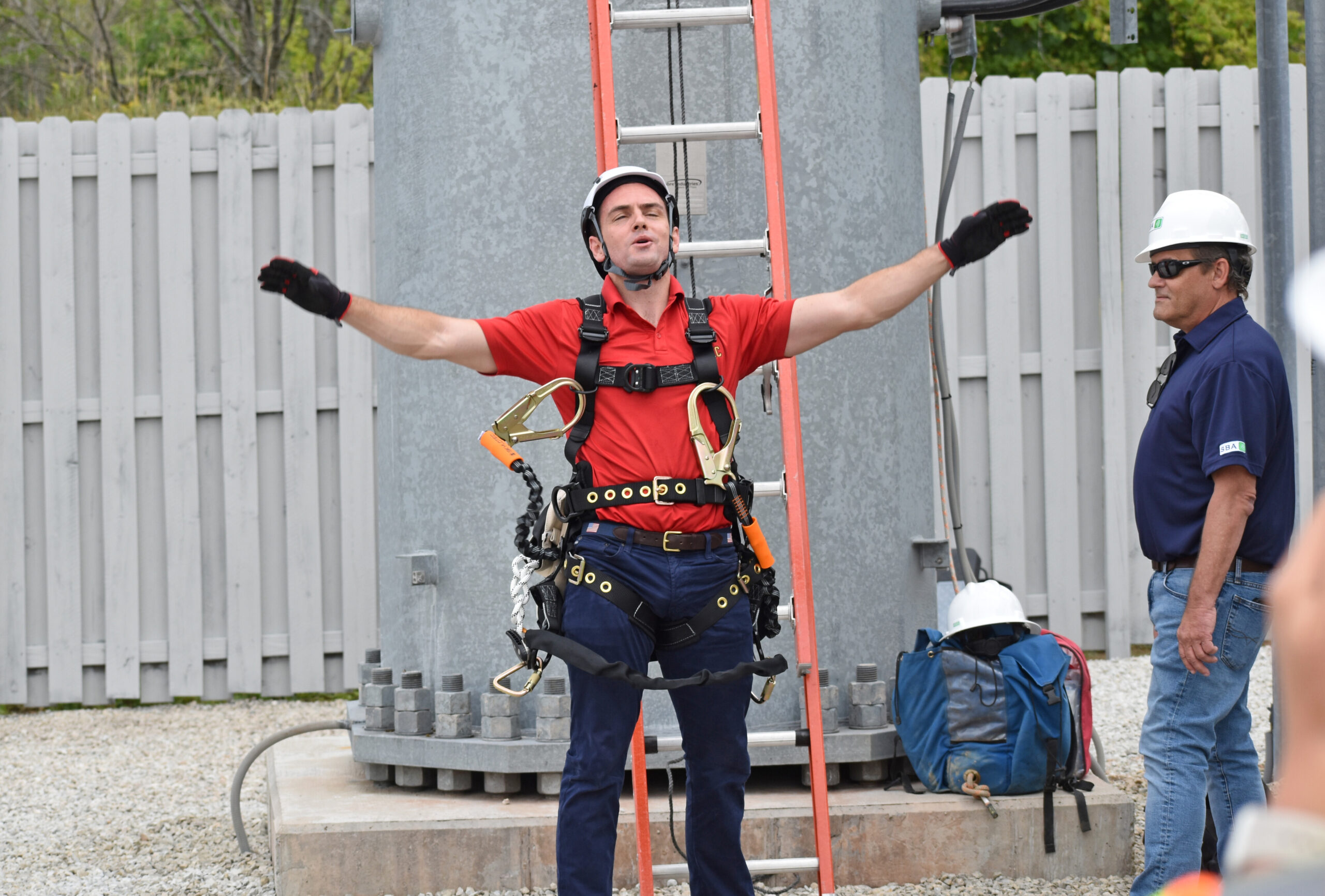 Mike Gallagher celebrates after climbing a cell tower