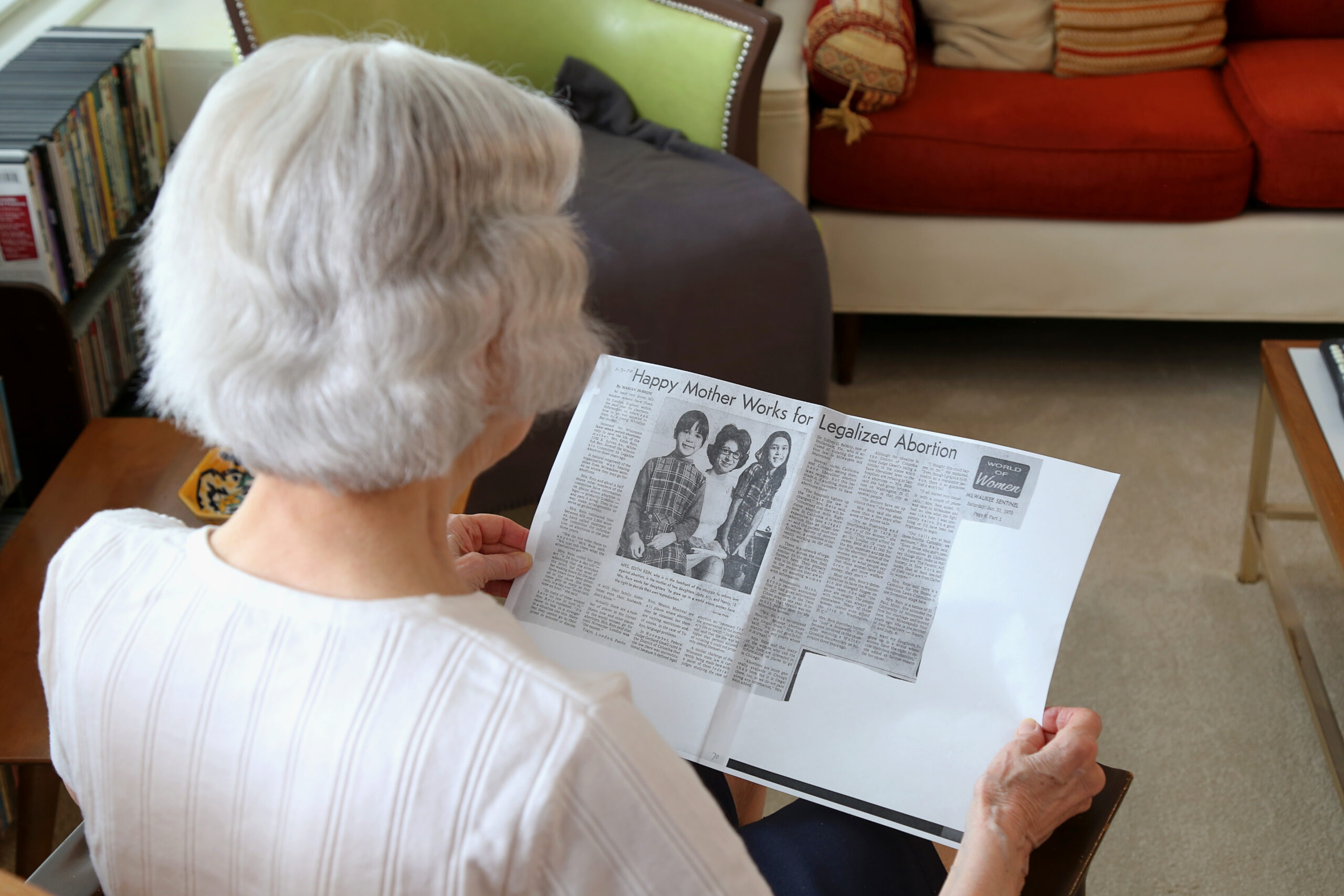 Edie Rein, 89, reads a 1970 newspaper profile from the Milwaukee Sentinel headlined "Happy Mother Works for Legalized Abortion."