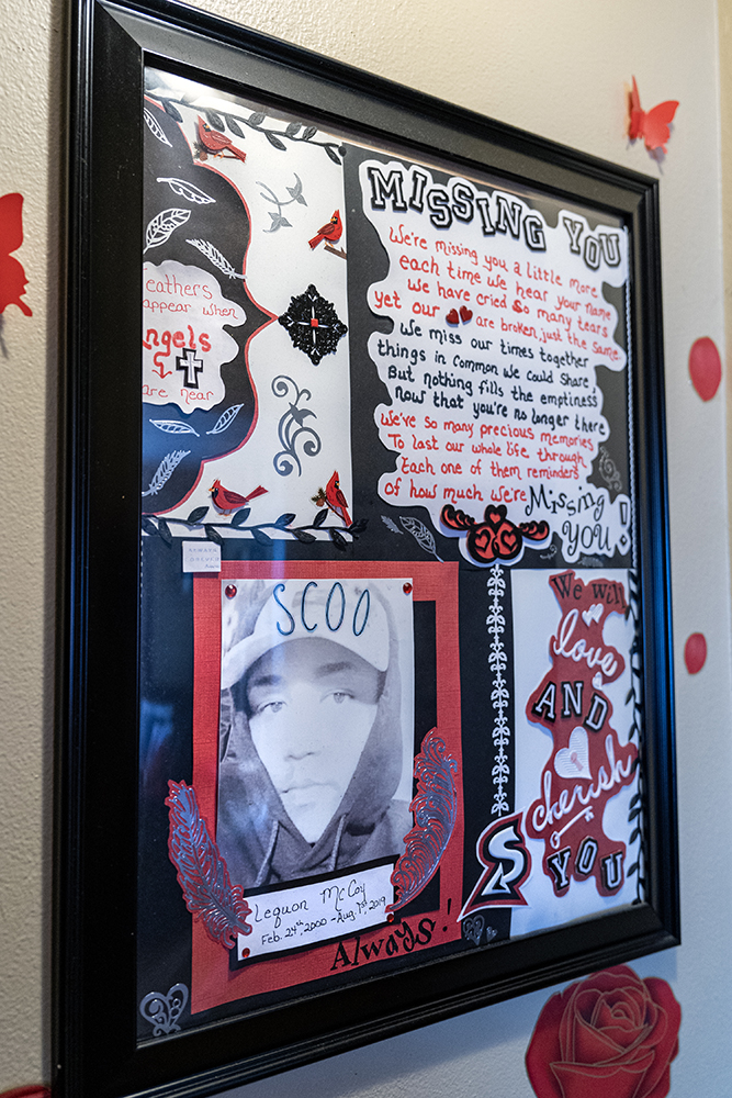 A collage of photos and messages made by family and friends for Le’Quon McCoy’s funeral hangs on the wall at the Milwaukee apartment of Antoinette Broomfield, his mother