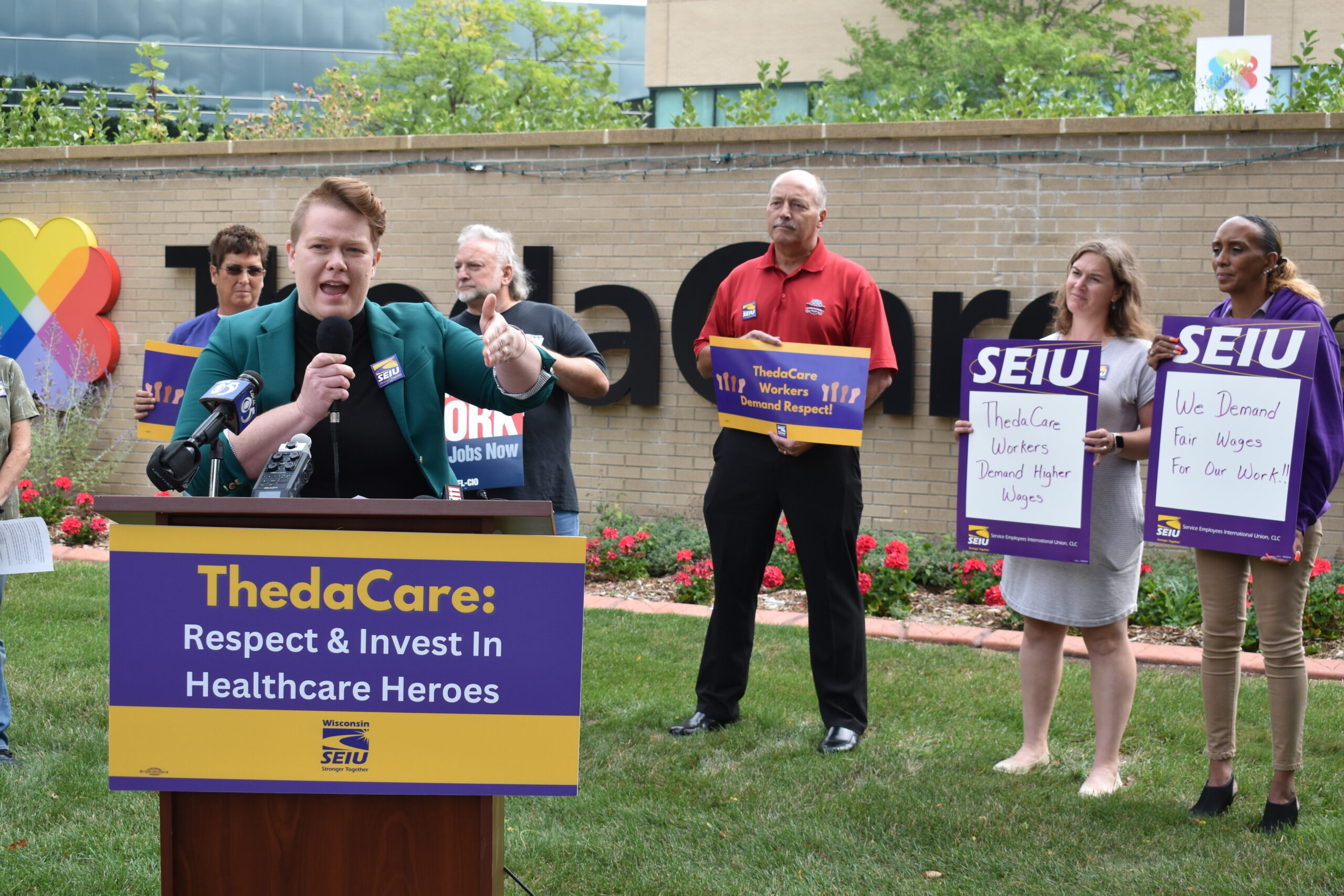The Rev. Hannah Roberts Villnave speaks from a podium outside ThedaCare Regional Medical Center–Appleton