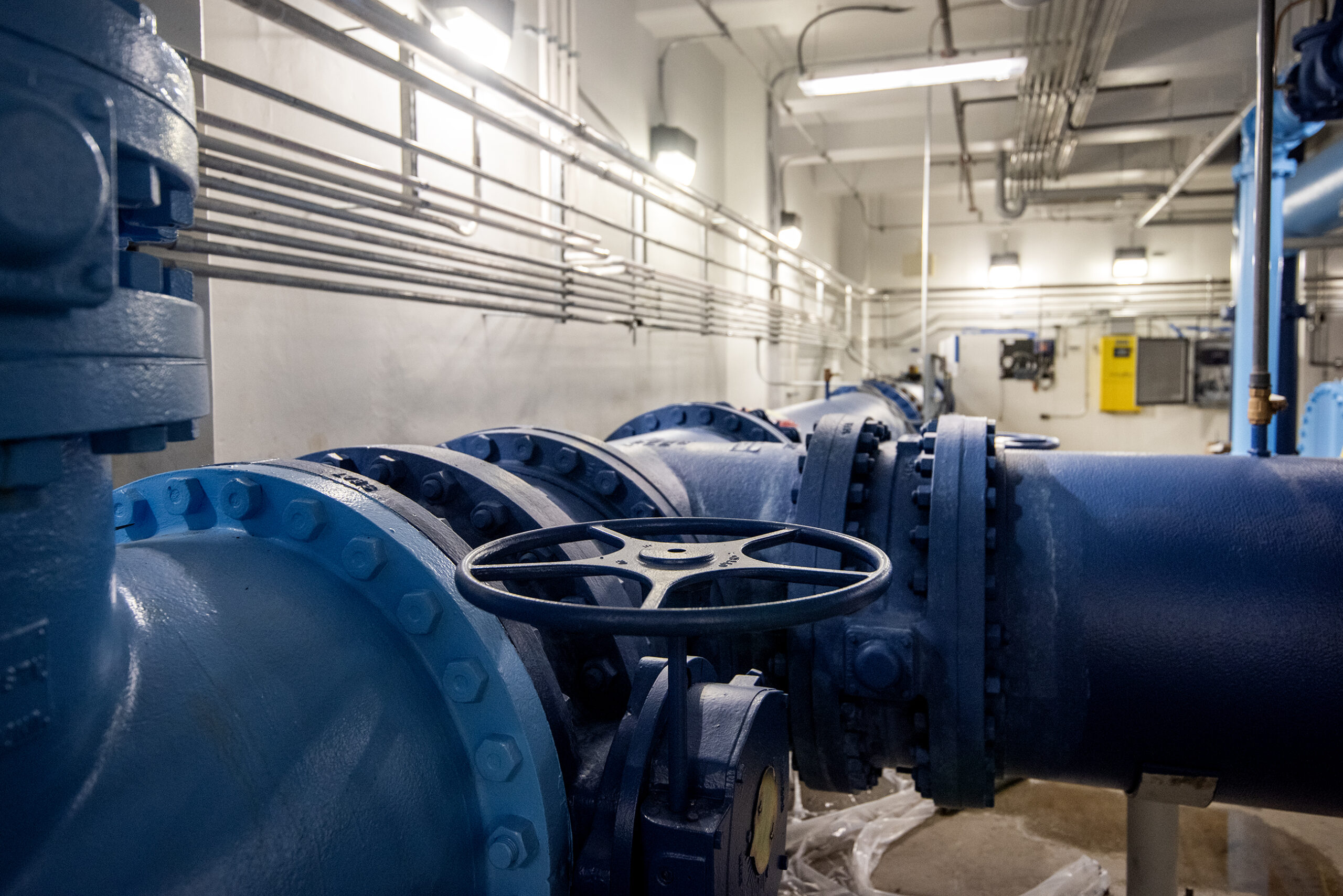 A wheel near a blue pump.