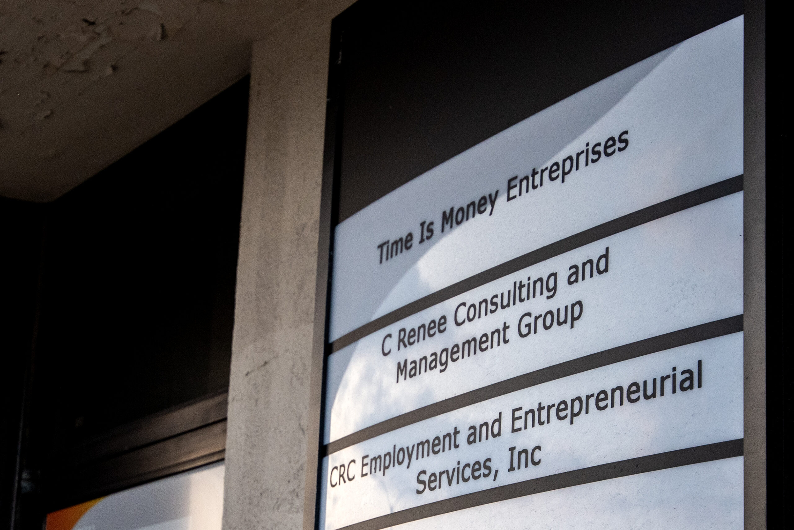 Businesses are listed on a white sign.