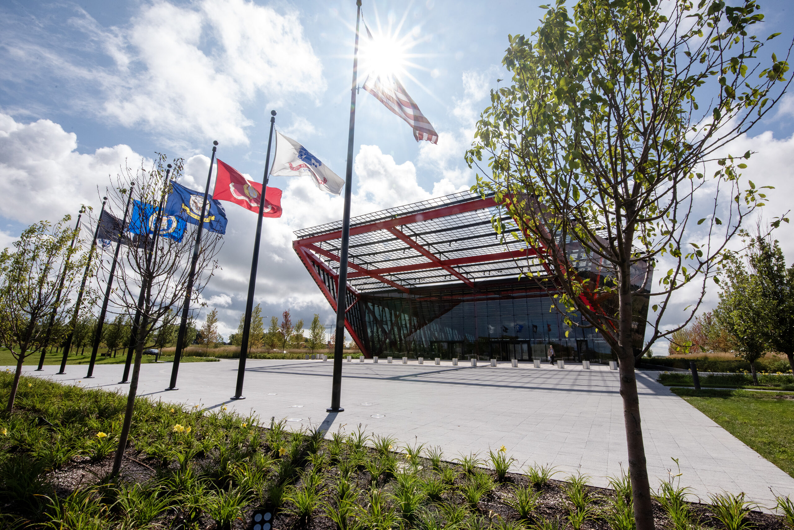 A US flag and other US military flags fly outside the museum.