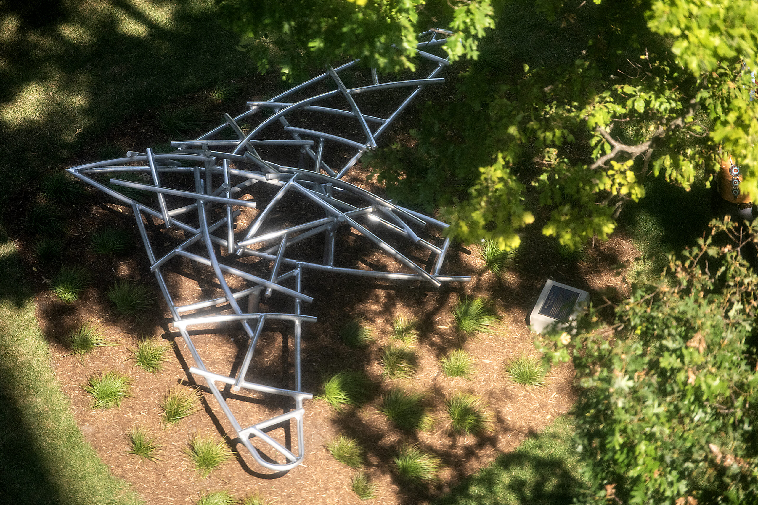 Silver bars from the shape of a bird in flight, seen from above.