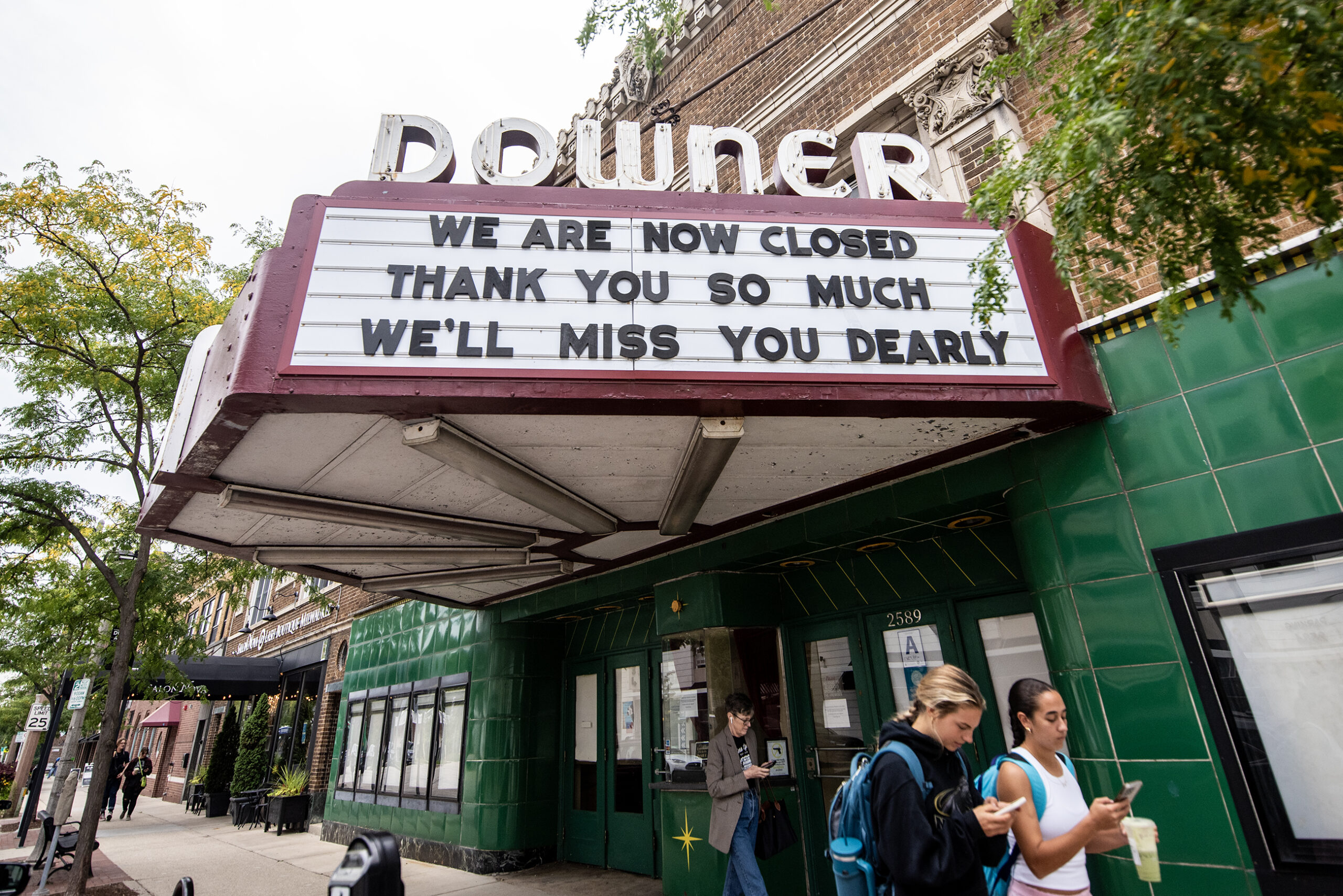 A movie theater sign says "We are now closed. Thank you so much. We'll miss you dearly."