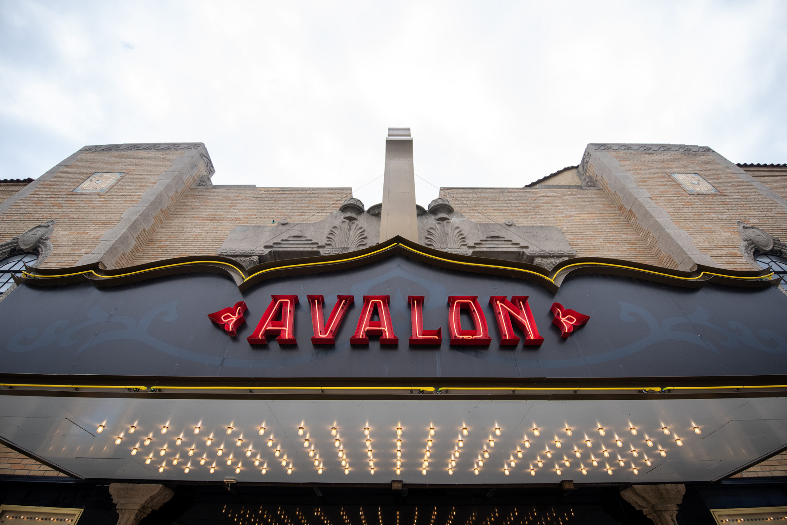 A red sign says "Avalon" outside a building.
