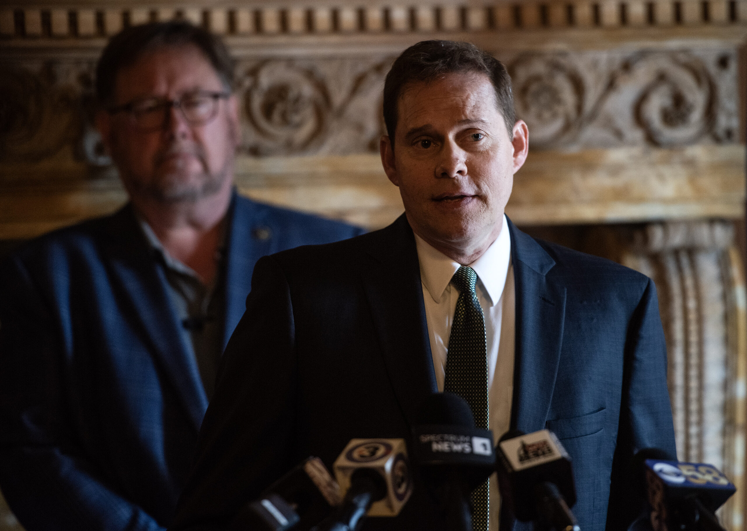 A man speaks at a press conference.