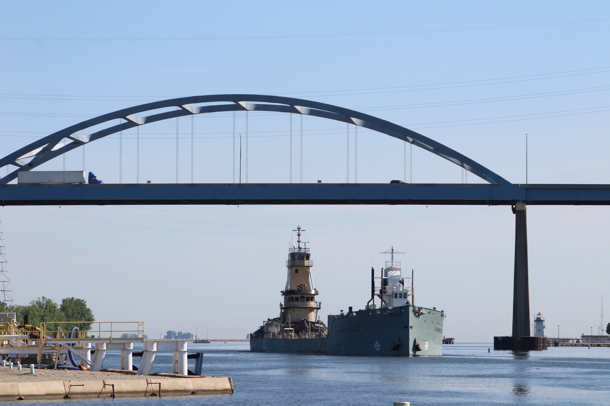 A ship passing underneath a bridge