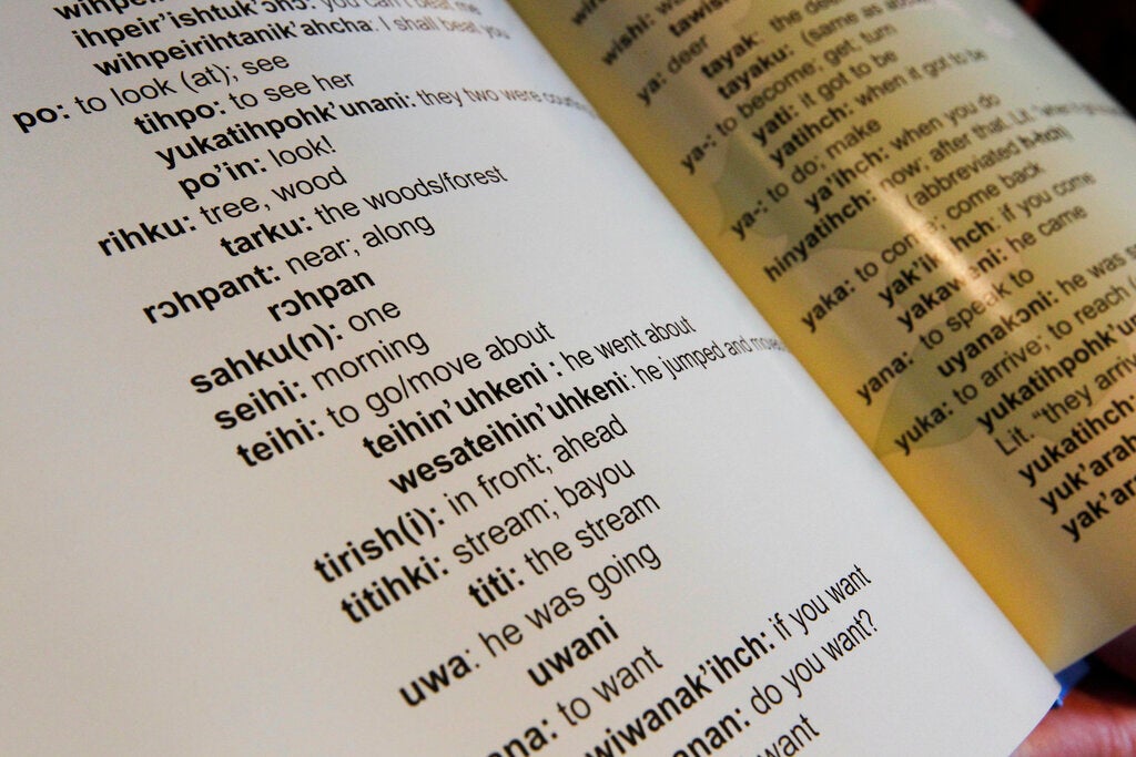 In this Aug. 5, 2011 photo, Brenda Lintinger holds one of her children's books she wrote in the Tunica Indian language, in her home in Metairie, La. Lintinger decided to do more than learn a new language: she set out to resurrect the ancient tongue of her